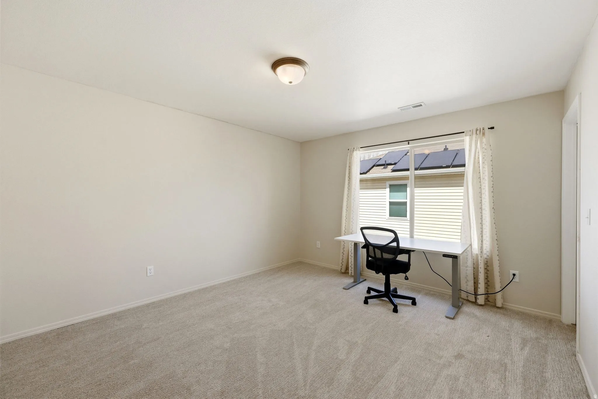 Unfurnished office with baseboards and light colored carpet