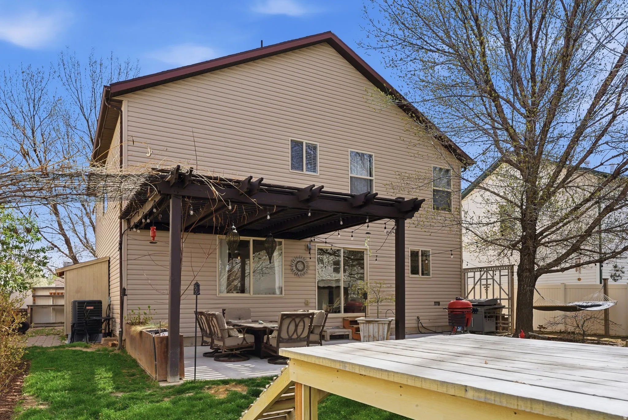 Back of house featuring a pergola and a patio area