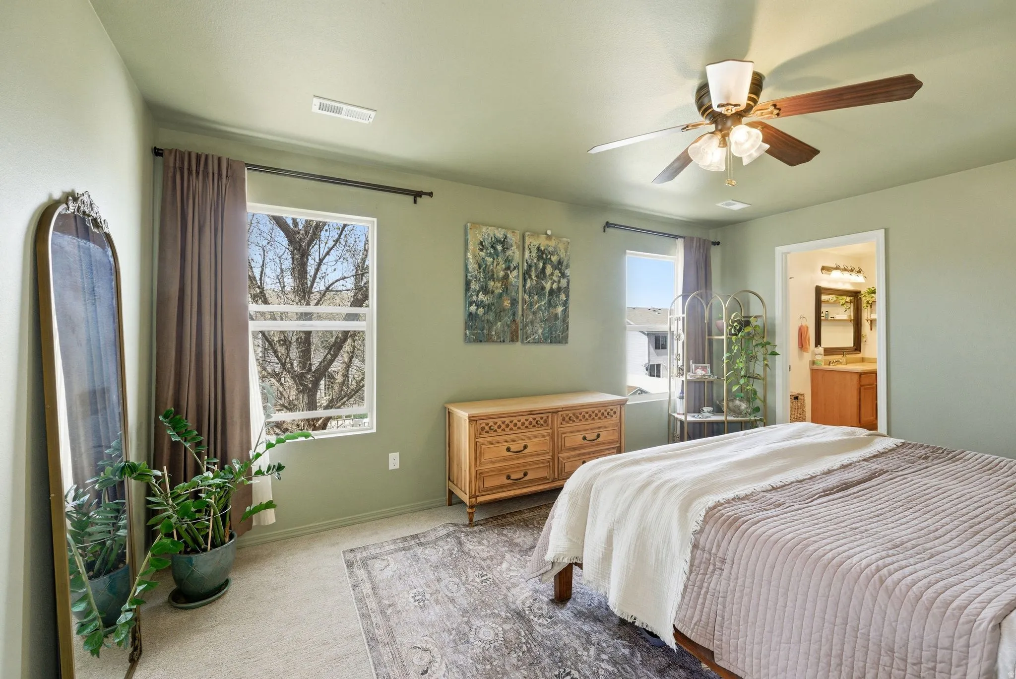 Carpeted bedroom with a ceiling fan and ensuite bathroom