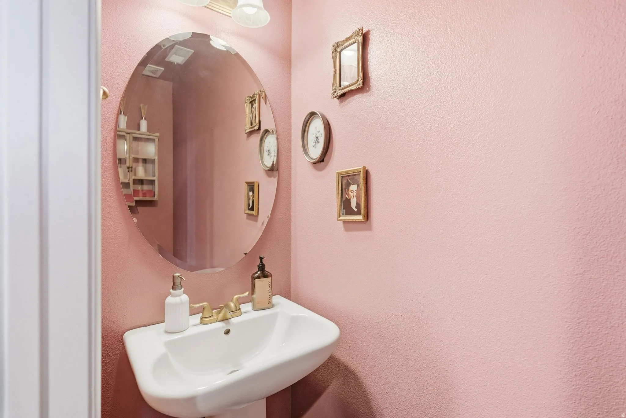 Bathroom featuring a sink and a textured wall
