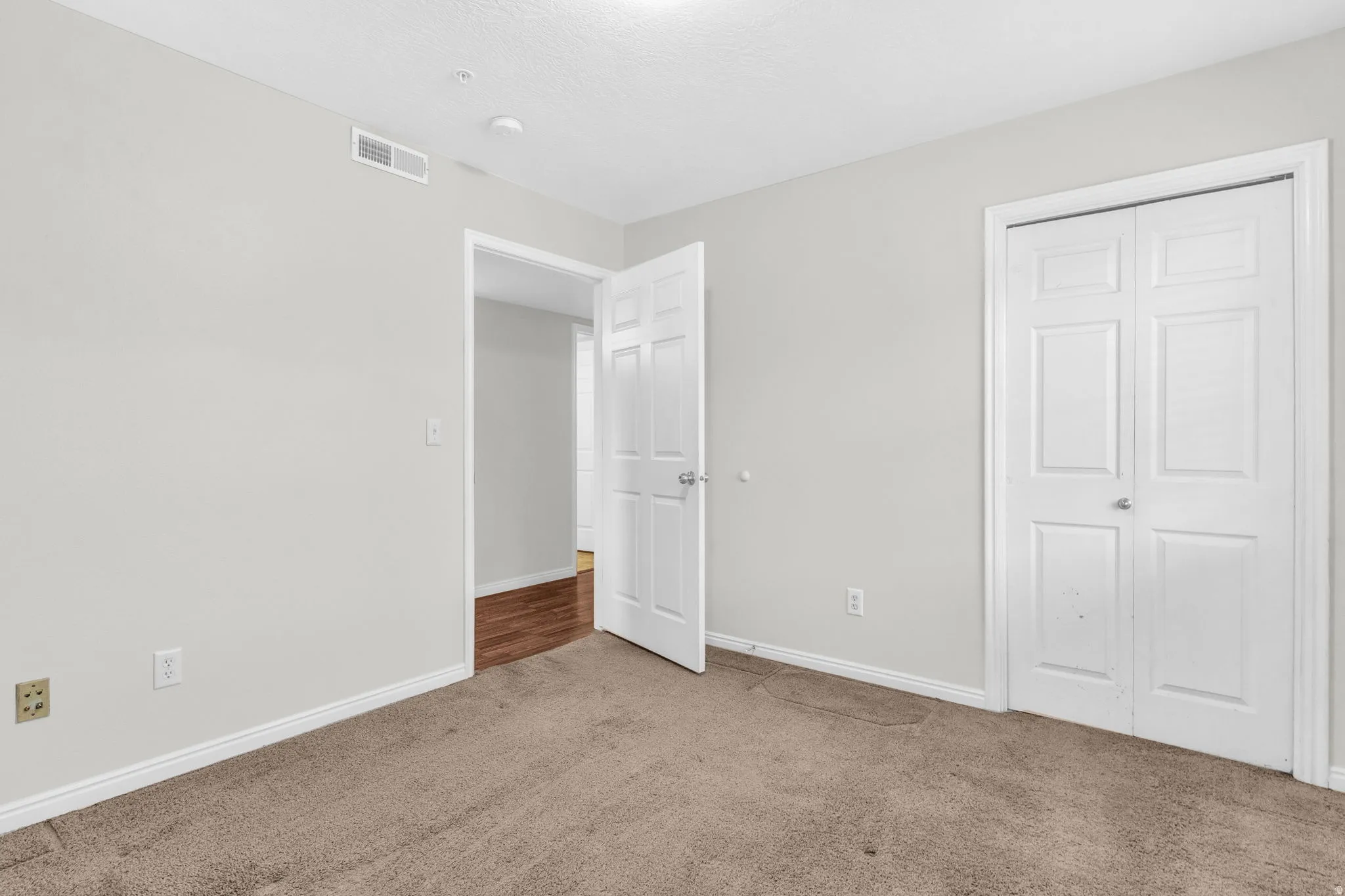 Unfurnished bedroom featuring baseboards and carpet flooring