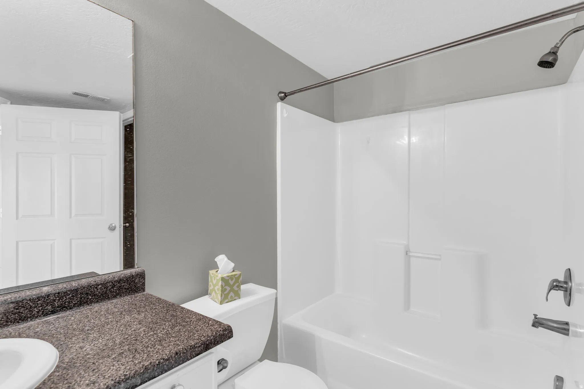 Full bath featuring vanity and shower / washtub combination