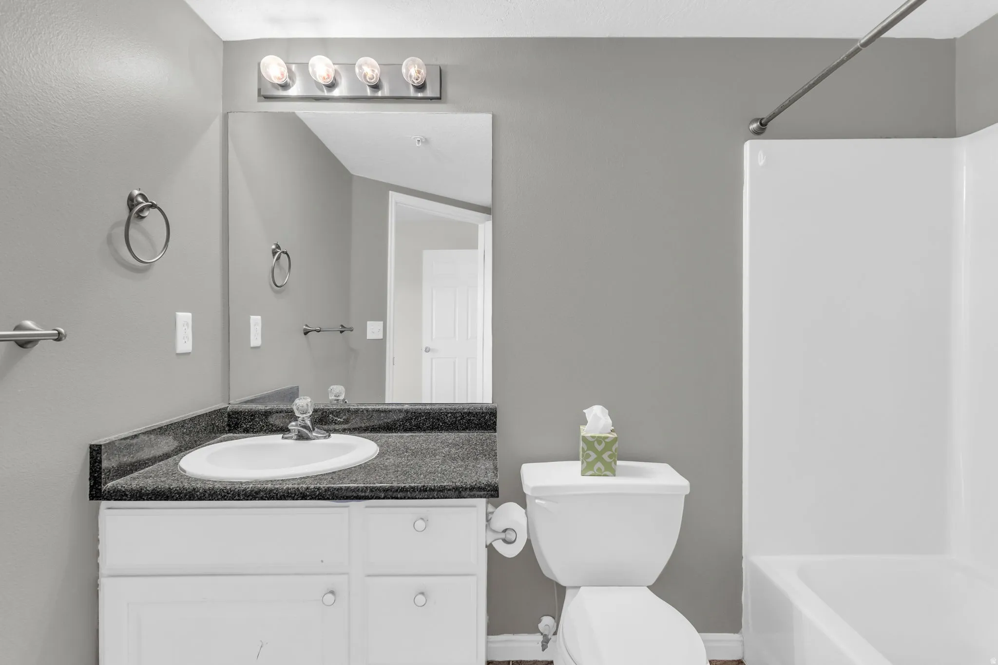 Bathroom with vanity and washtub / shower combination