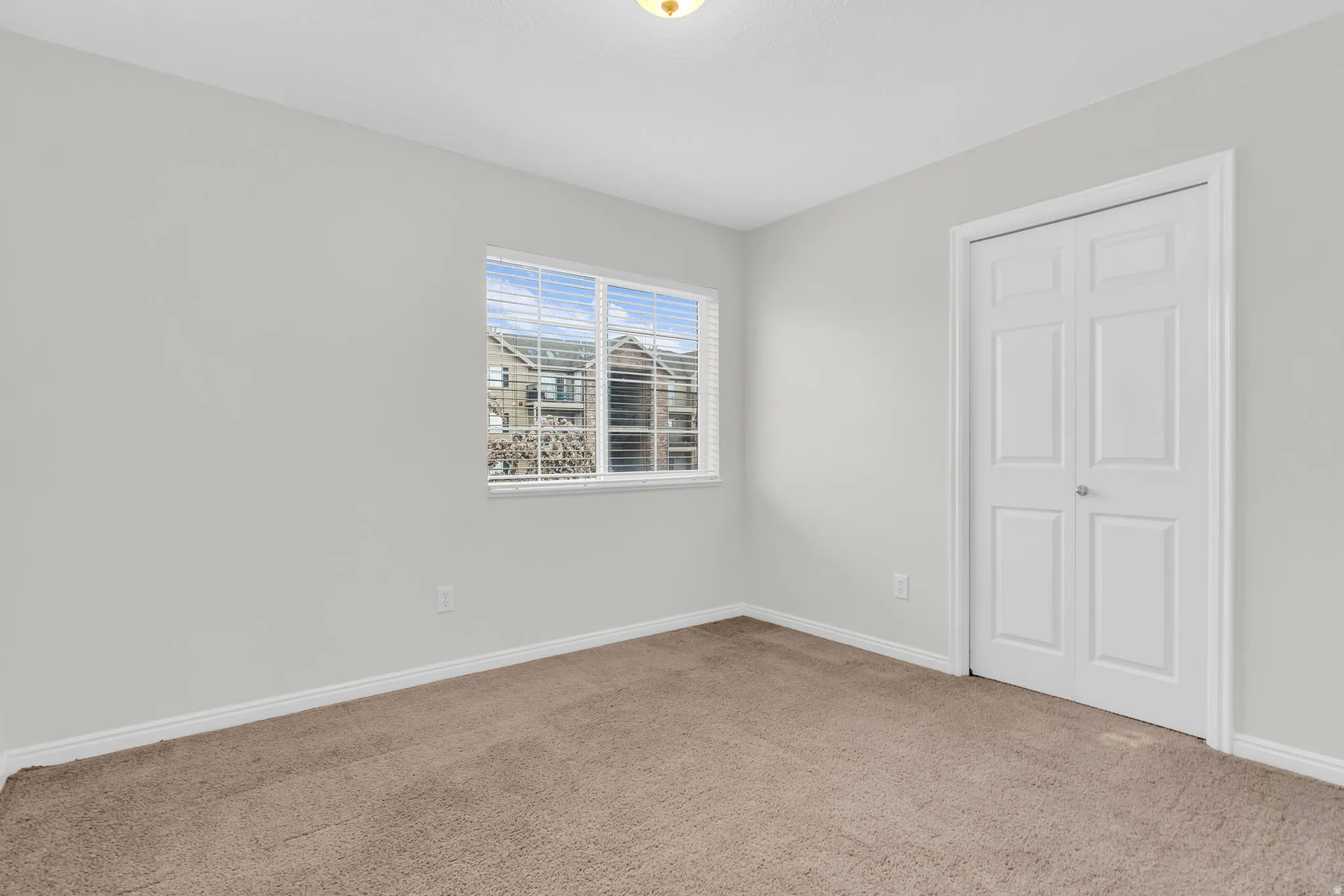 Unfurnished bedroom featuring carpet flooring and baseboards