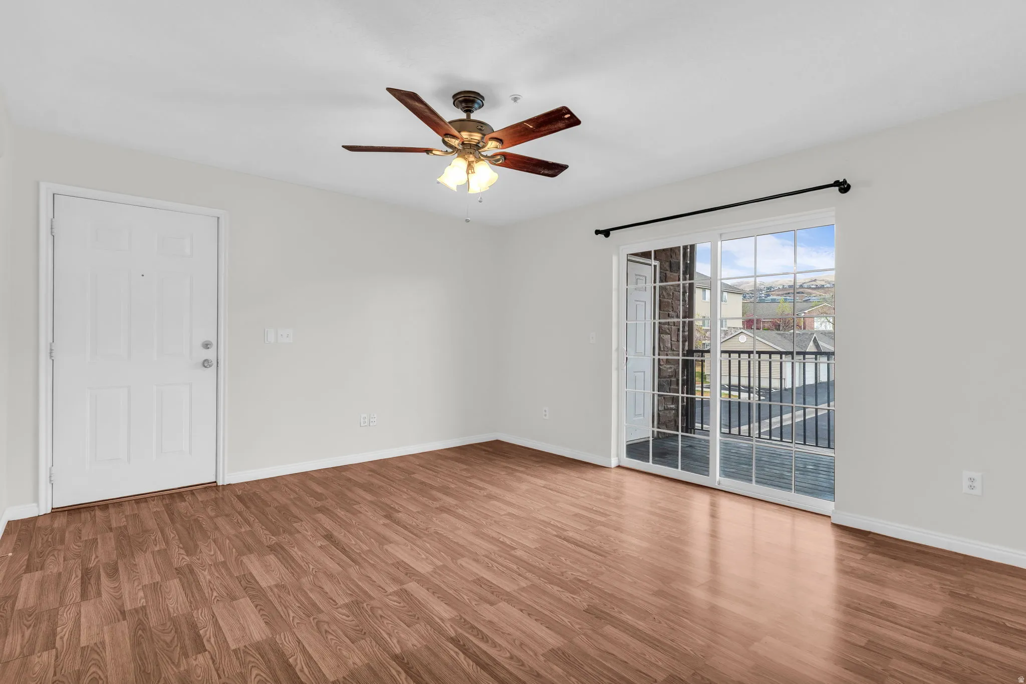 Empty room featuring wood finished floors and ceiling fan