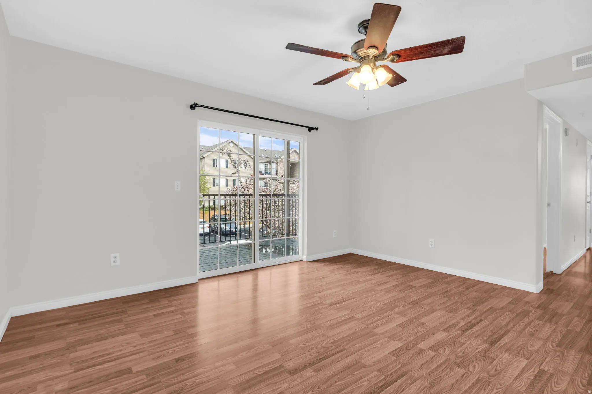 Empty room featuring wood finished floors and ceiling fan
