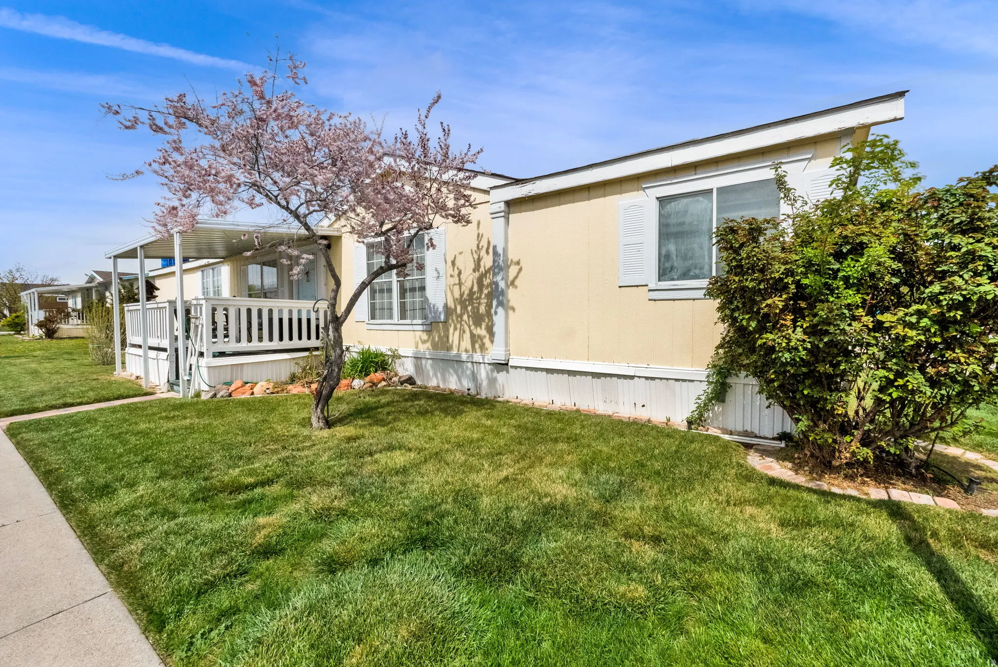 View of home's exterior with a lawn and a wooden deck