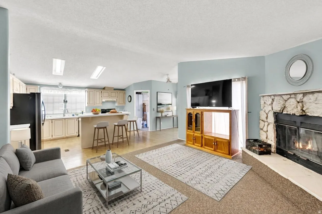 Living area featuring a fireplace and a textured ceiling