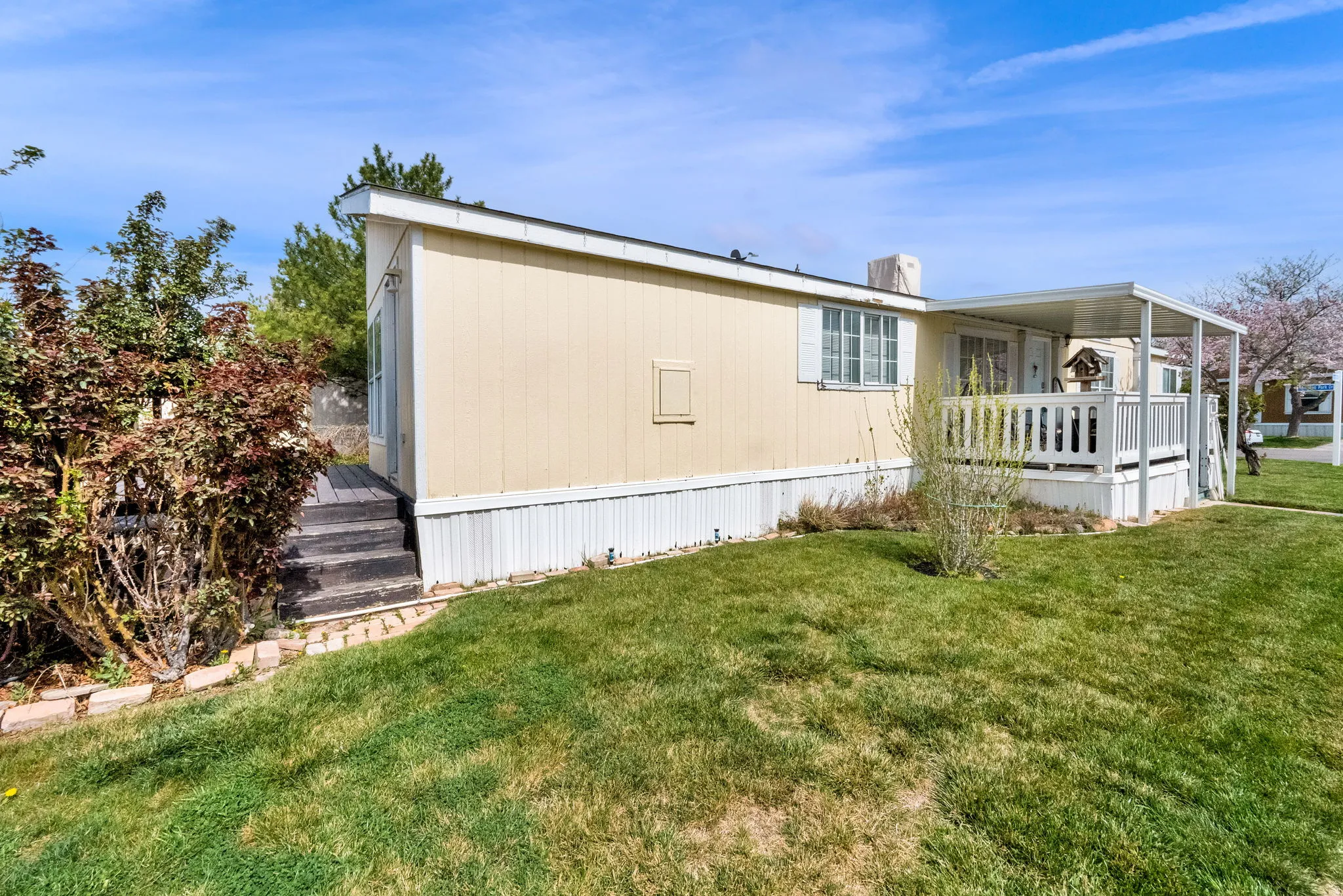 View of home's exterior with a yard and a cooling unit