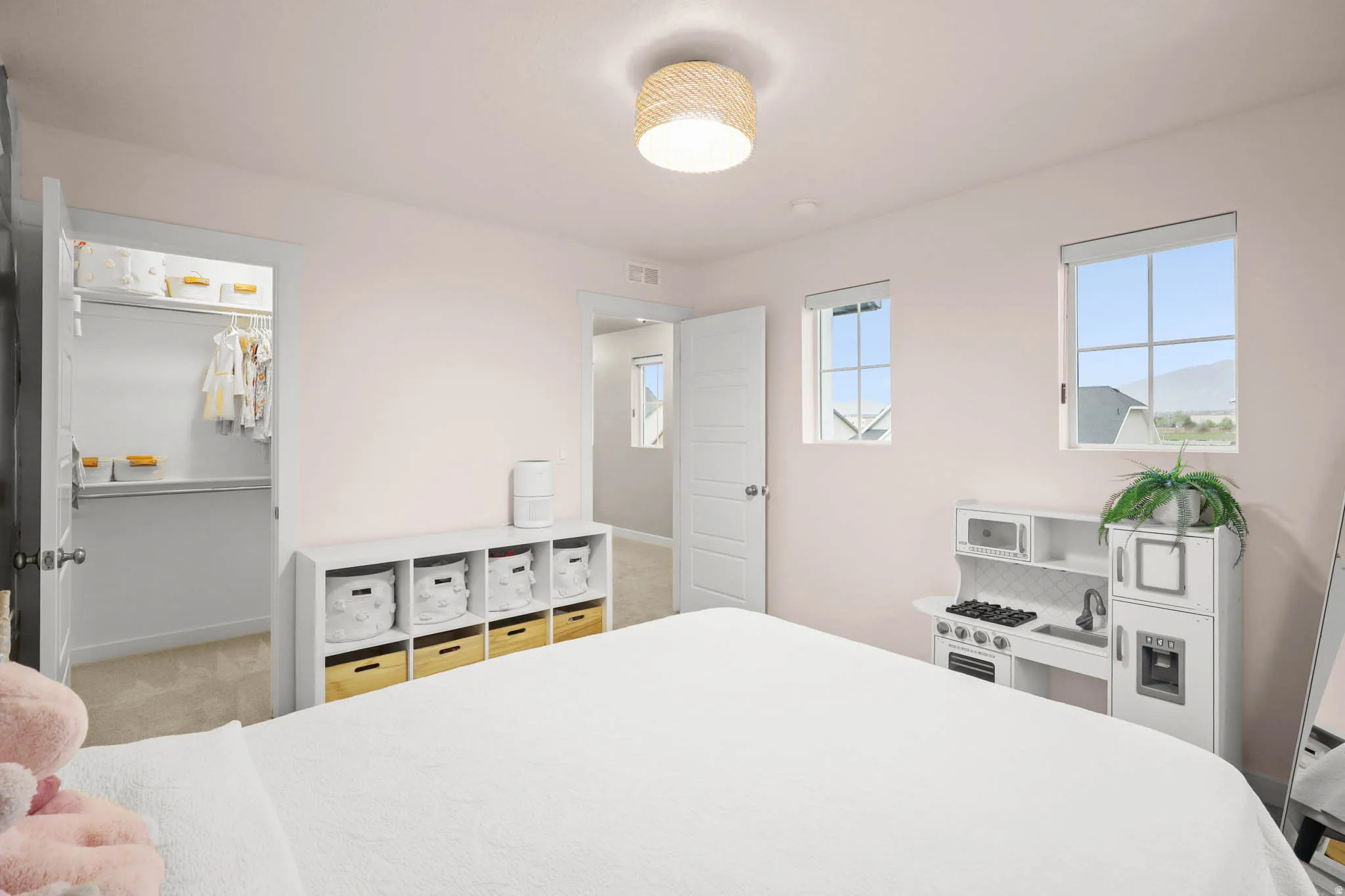 Bedroom featuring a walk in closet and carpet floors