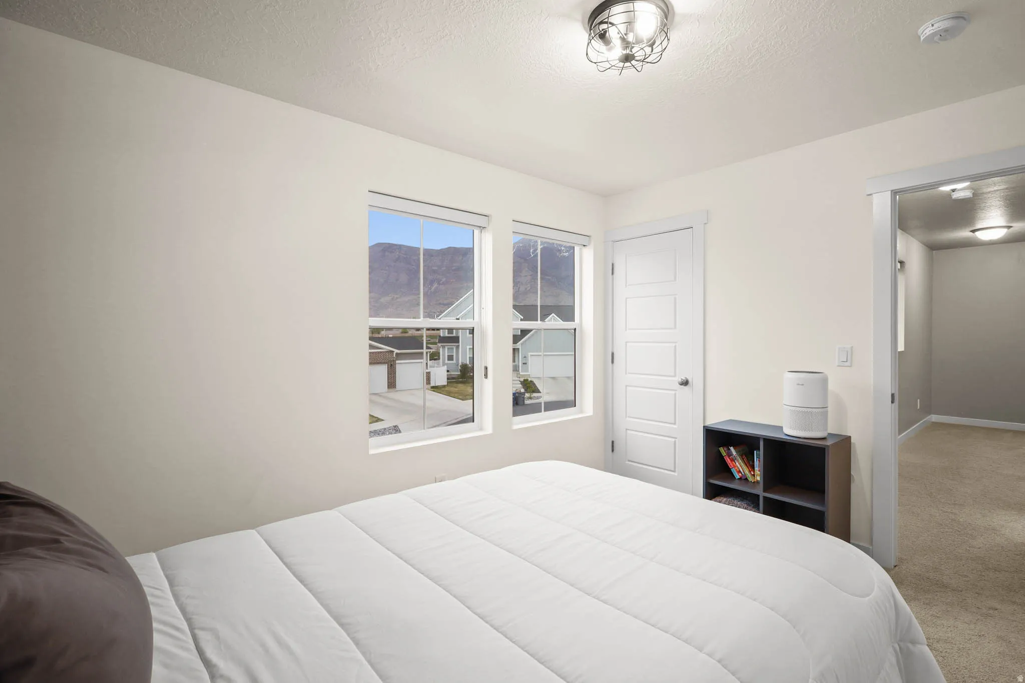 Bedroom with carpet floors and a textured ceiling