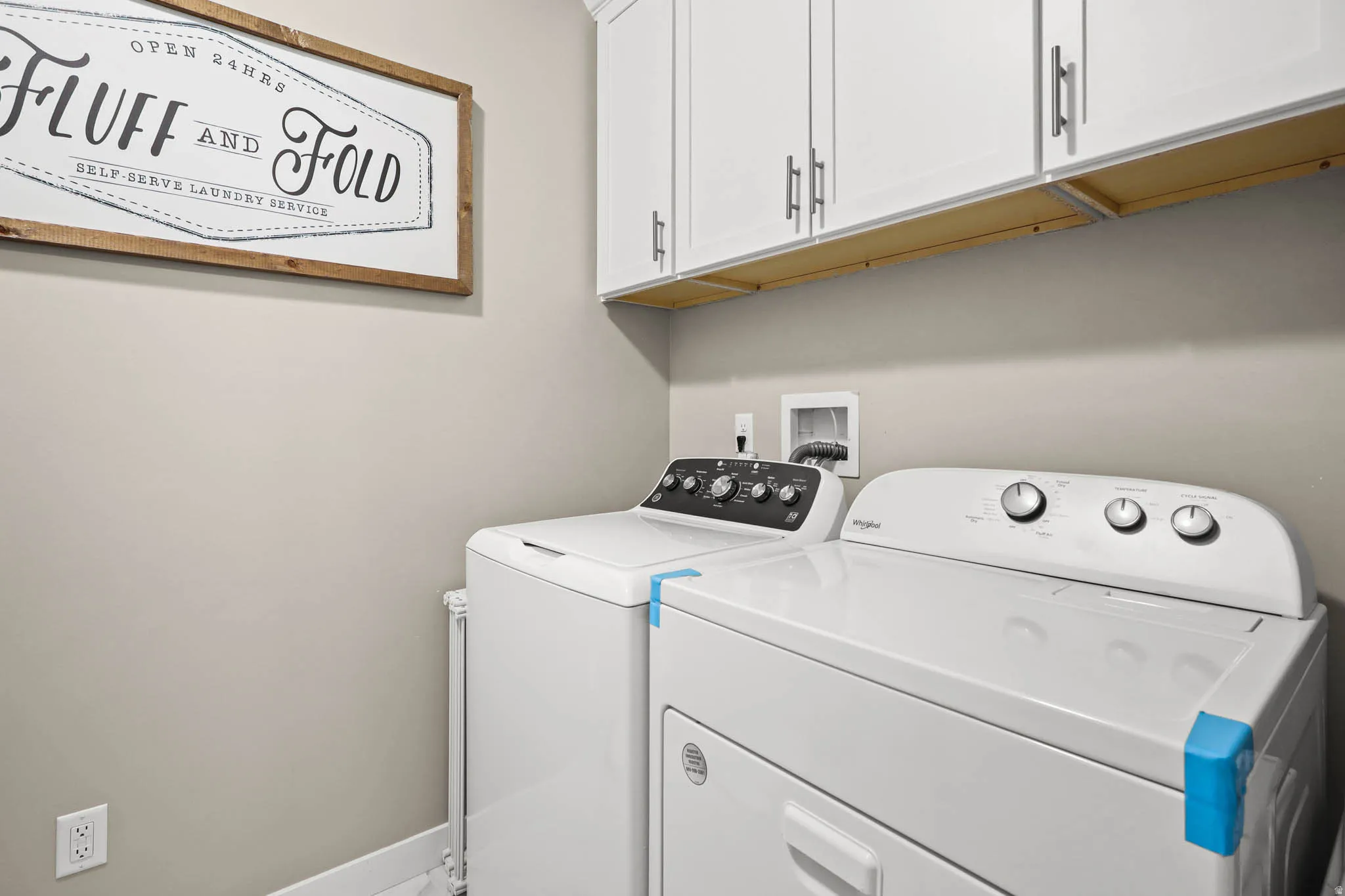 Laundry area with cabinet space and independent washer and dryer