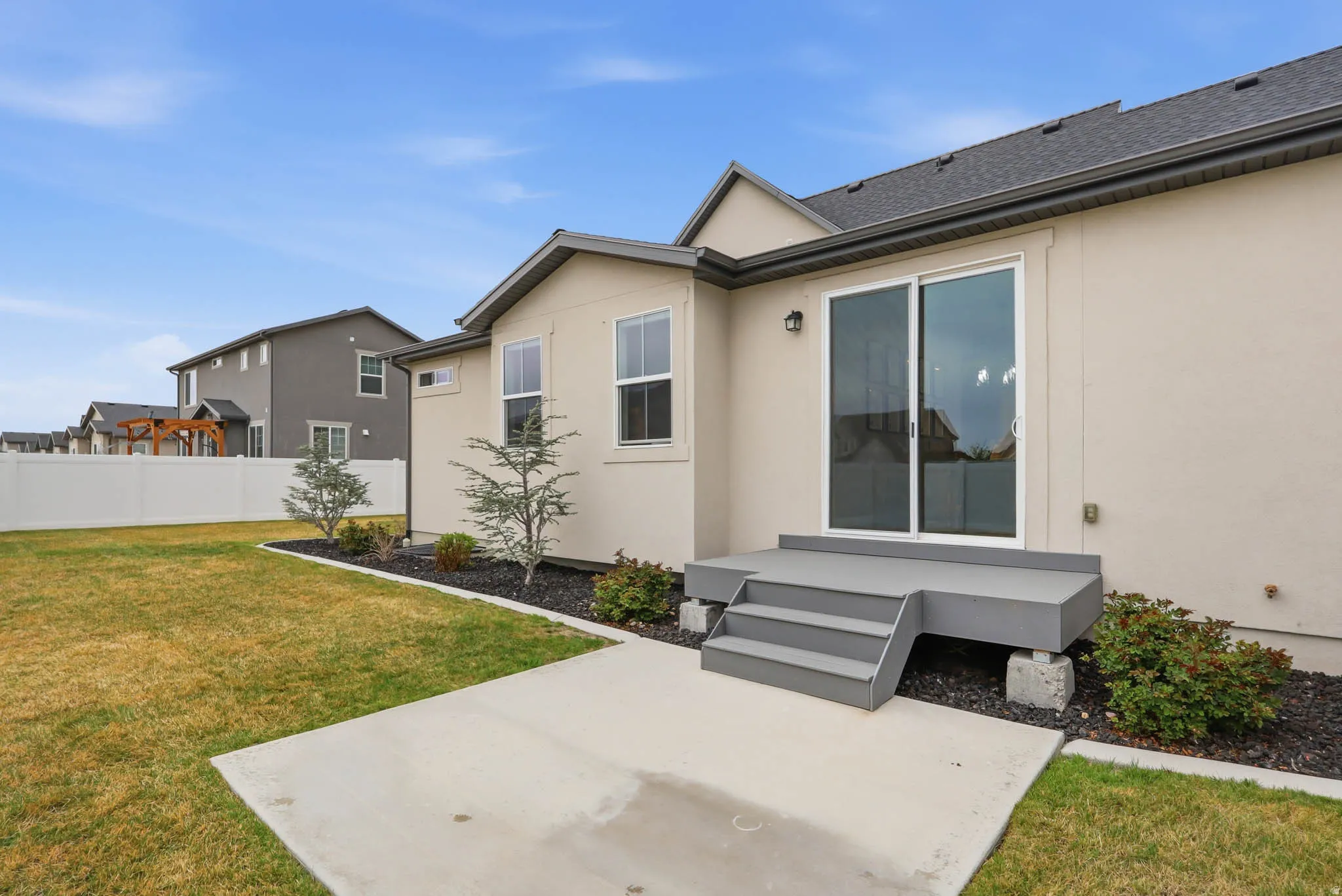 Rear view of property with stucco siding and a patio area