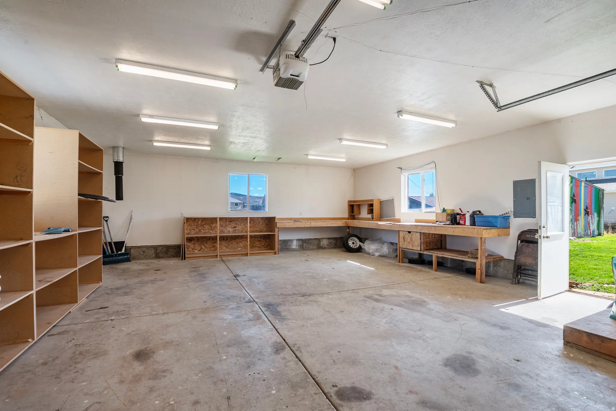 Garage with electric panel and a garage door opener
