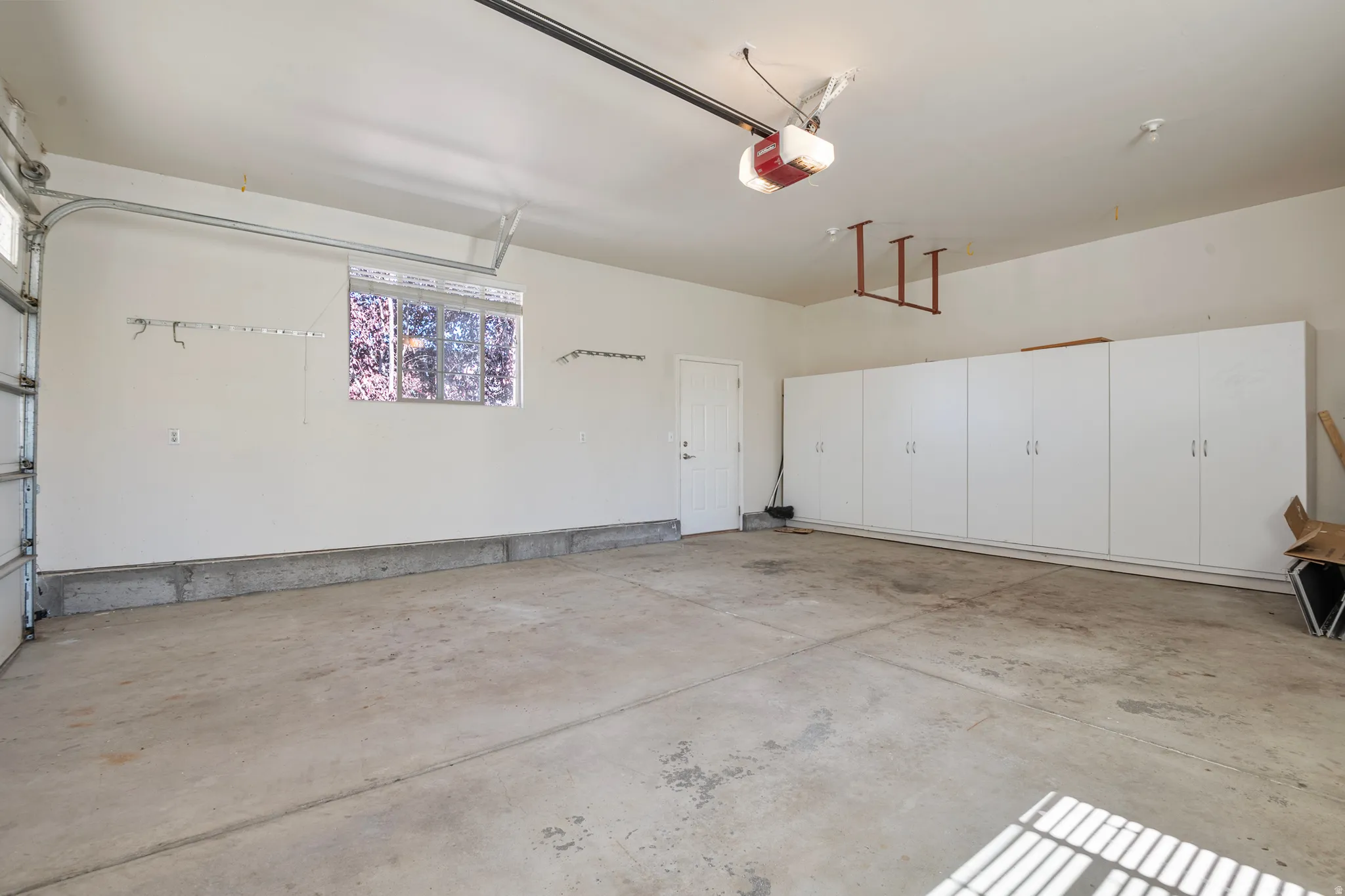 Garage featuring a garage door opener