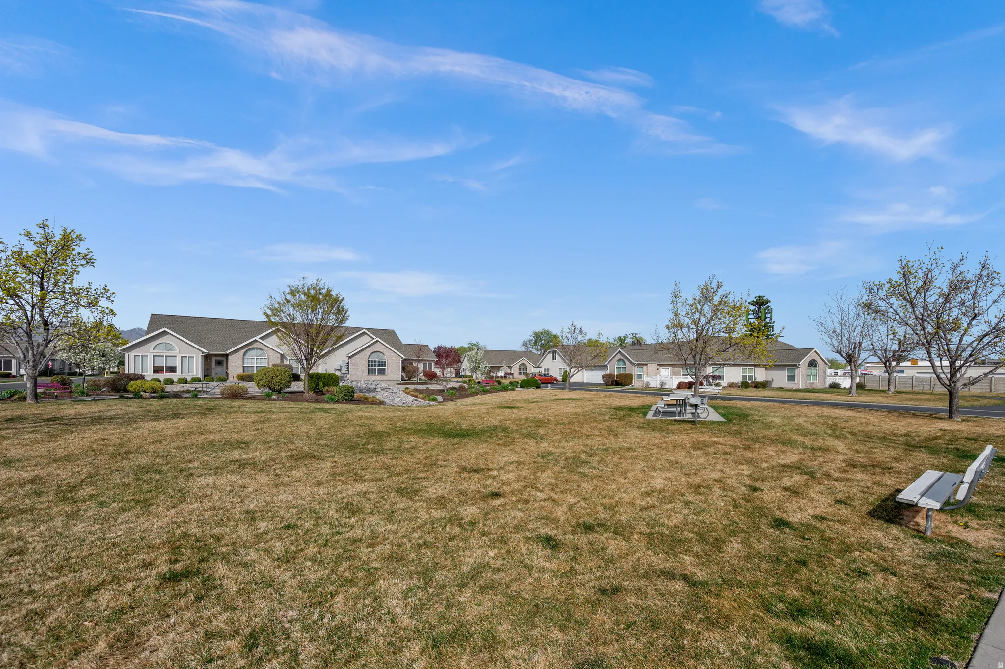 View of green lawn with a residential view