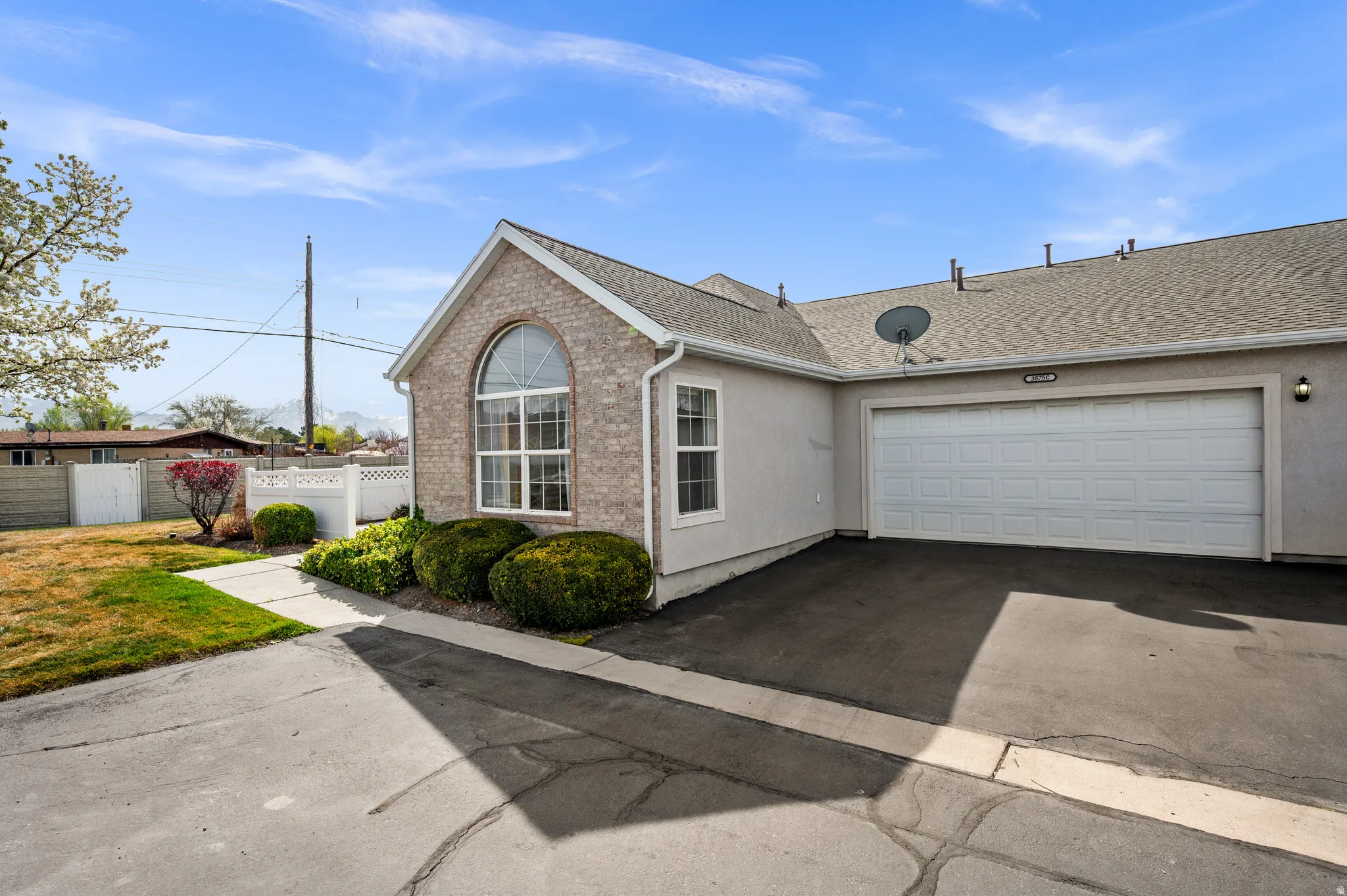 Ranch-style house with a shingled roof, asphalt driveway, and a garage