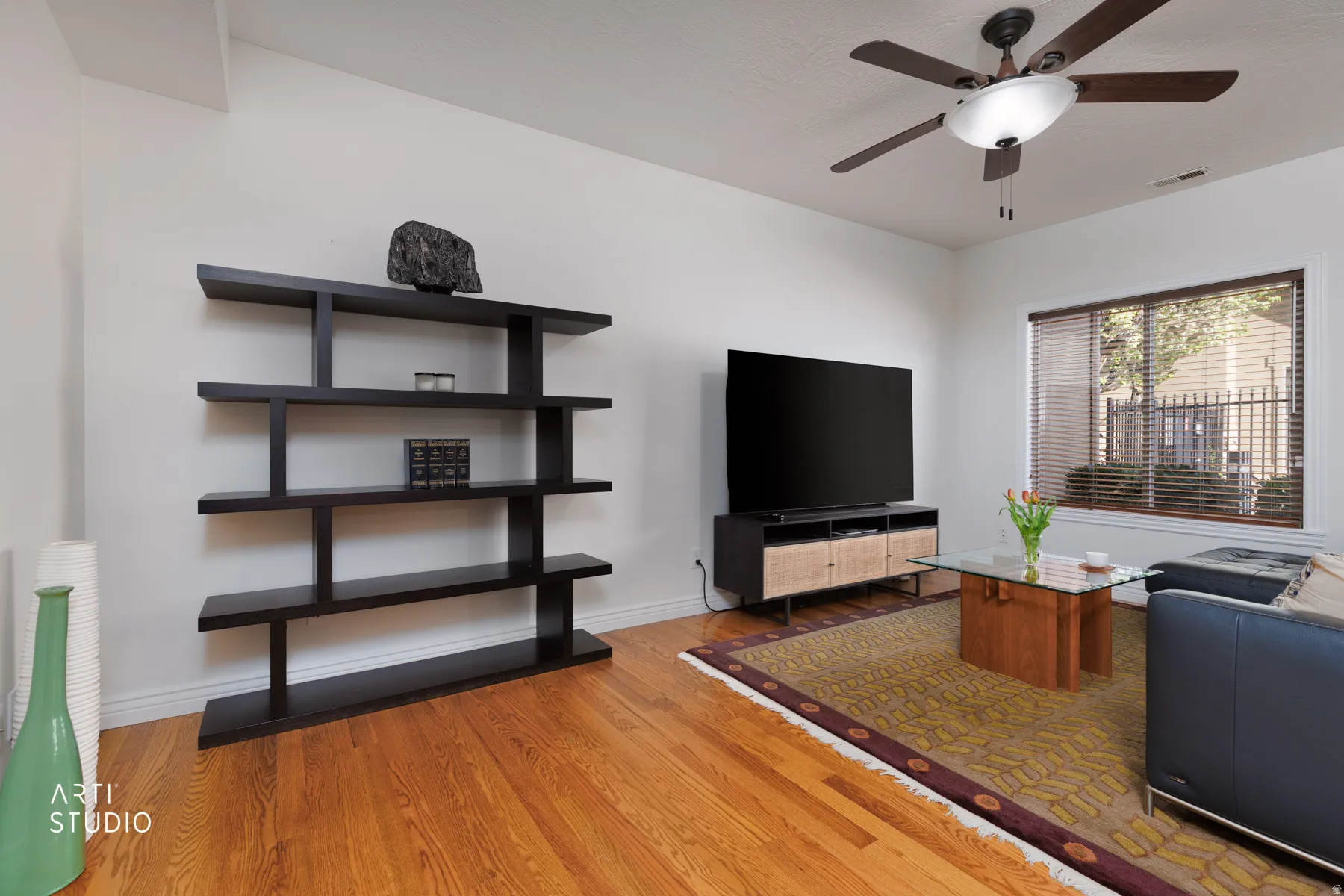 Living room with ceiling fan and light wood-style flooring