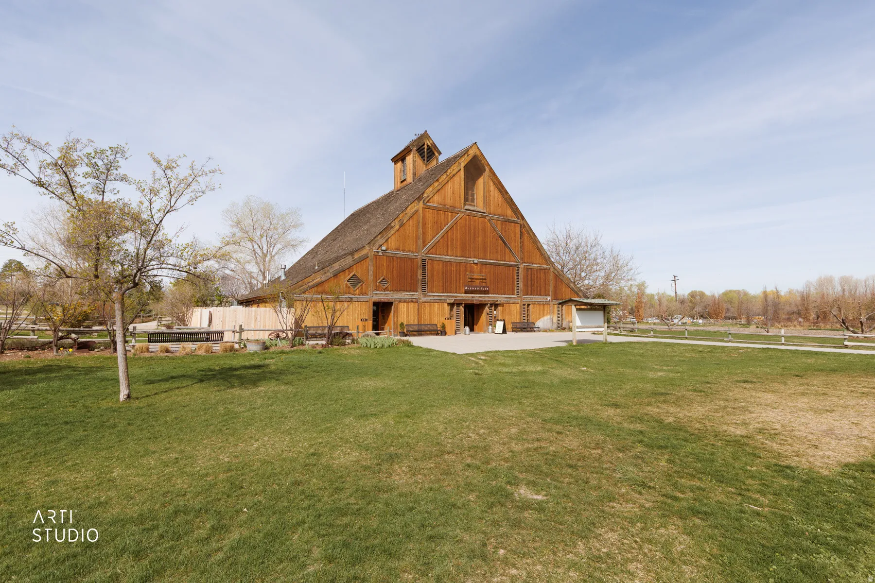 Back of property featuring a barn, a yard, and an outdoor structure