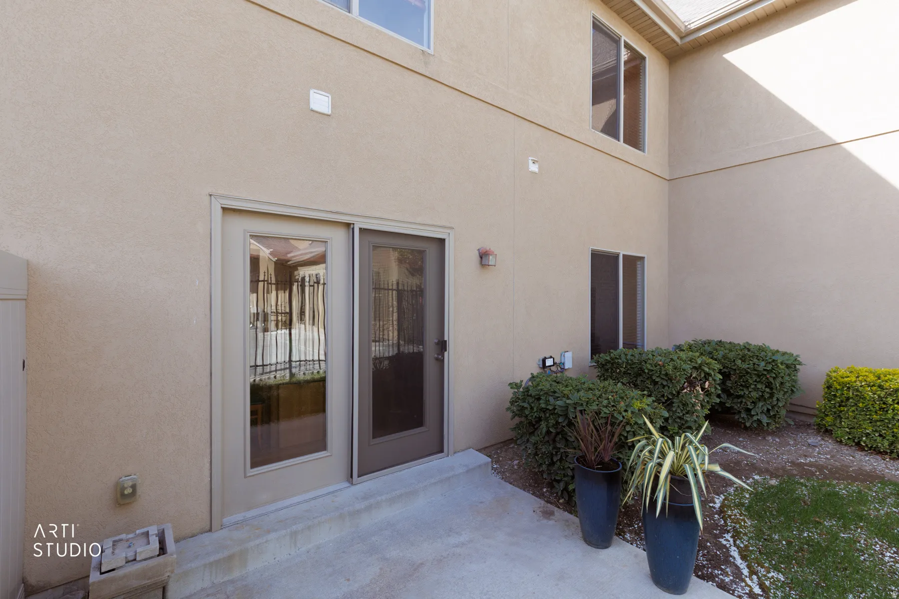Doorway to property with stucco siding and a patio area