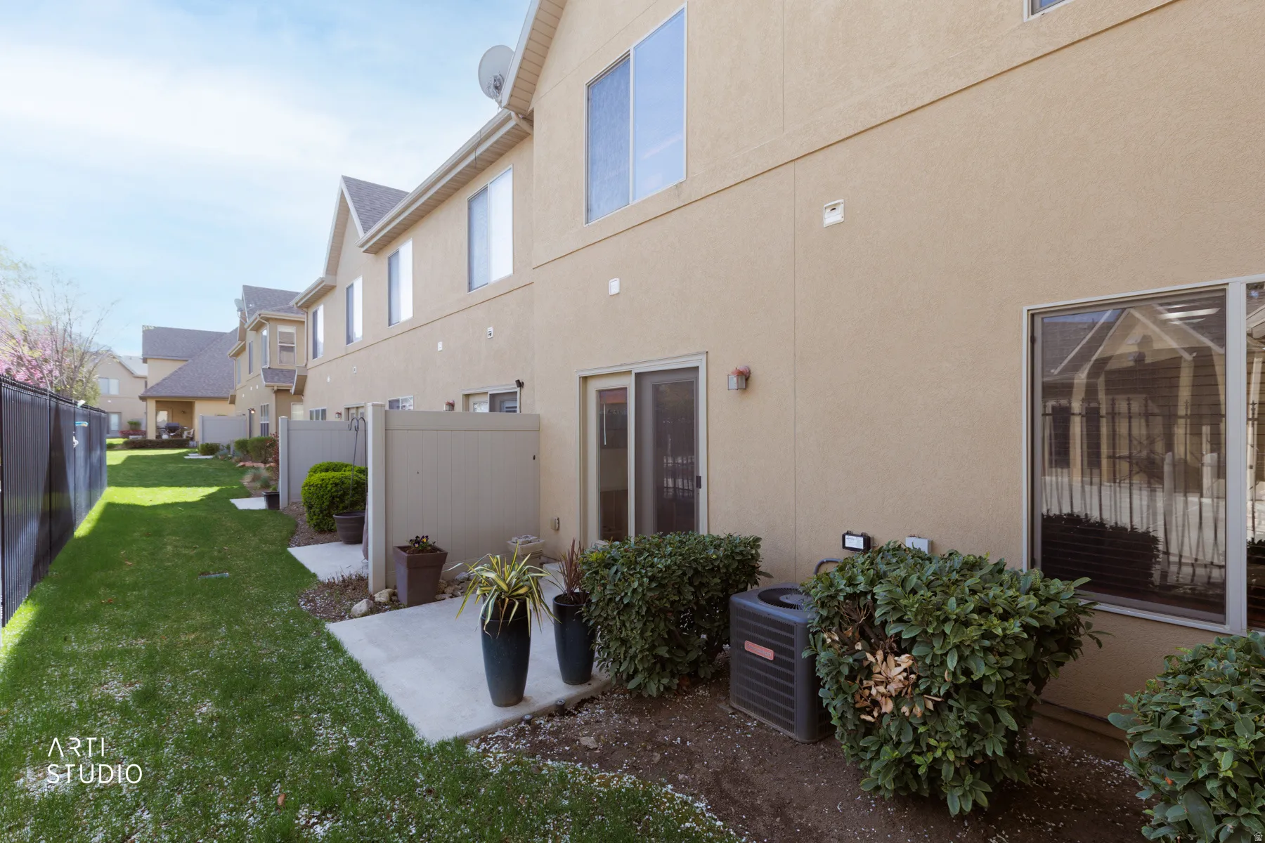 Back of property featuring stucco siding and a patio area