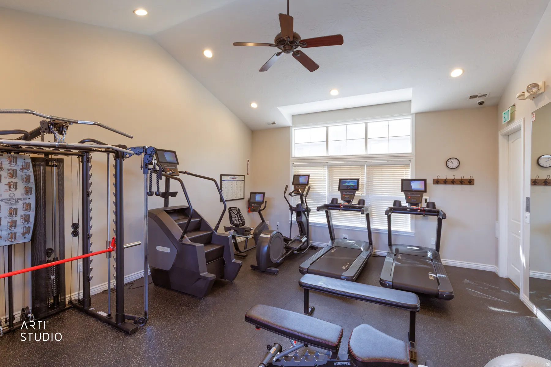 Workout area with recessed lighting, a ceiling fan, and a high ceiling