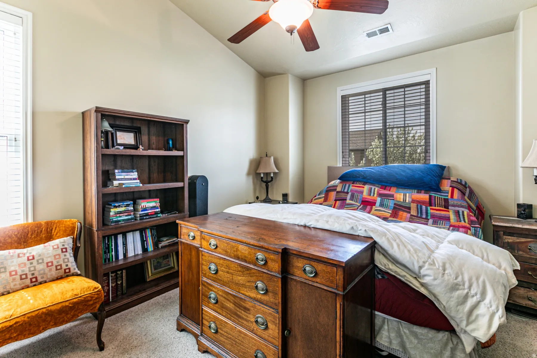 Bedroom featuring light carpet and a ceiling fan