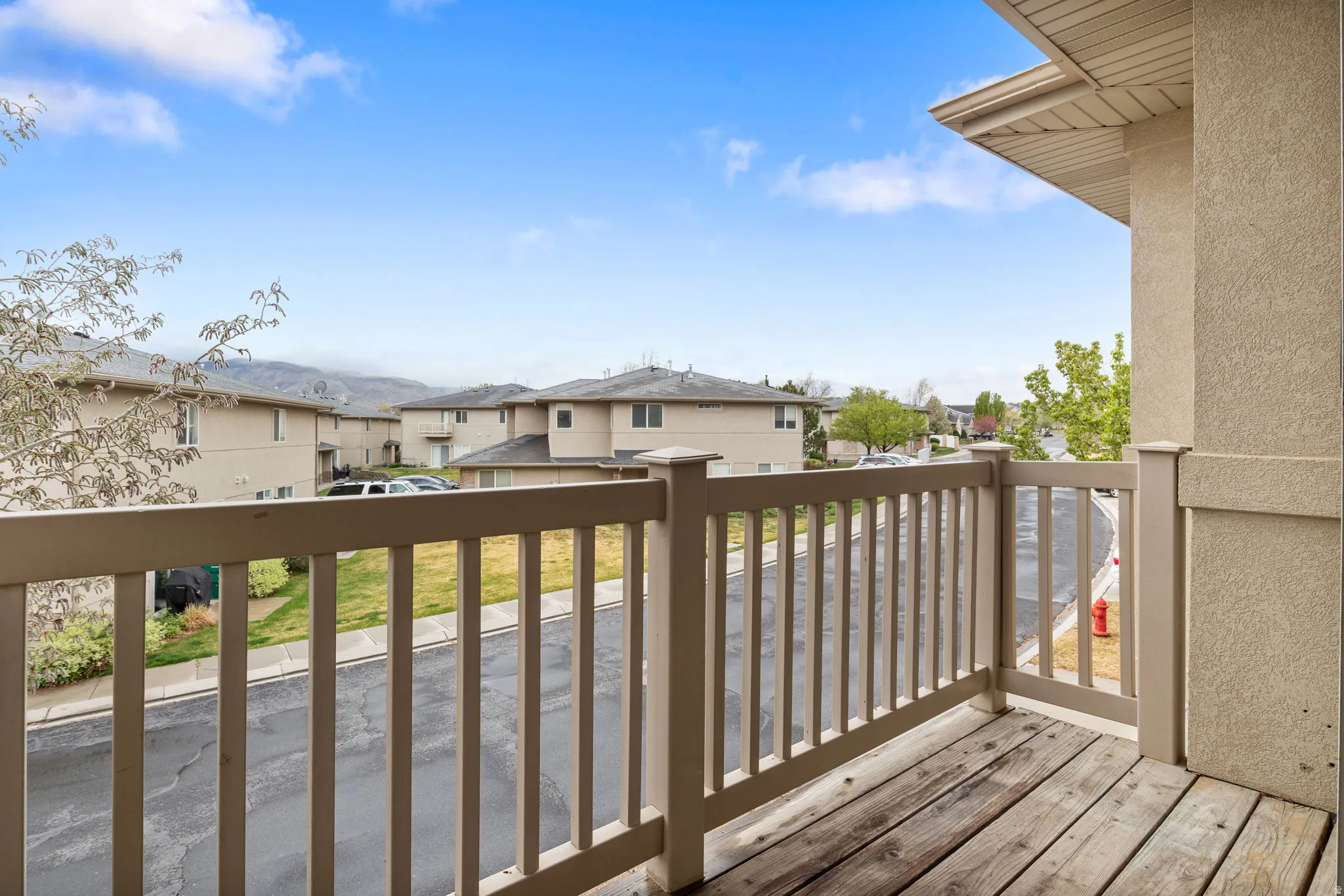 Wooden terrace featuring a residential view