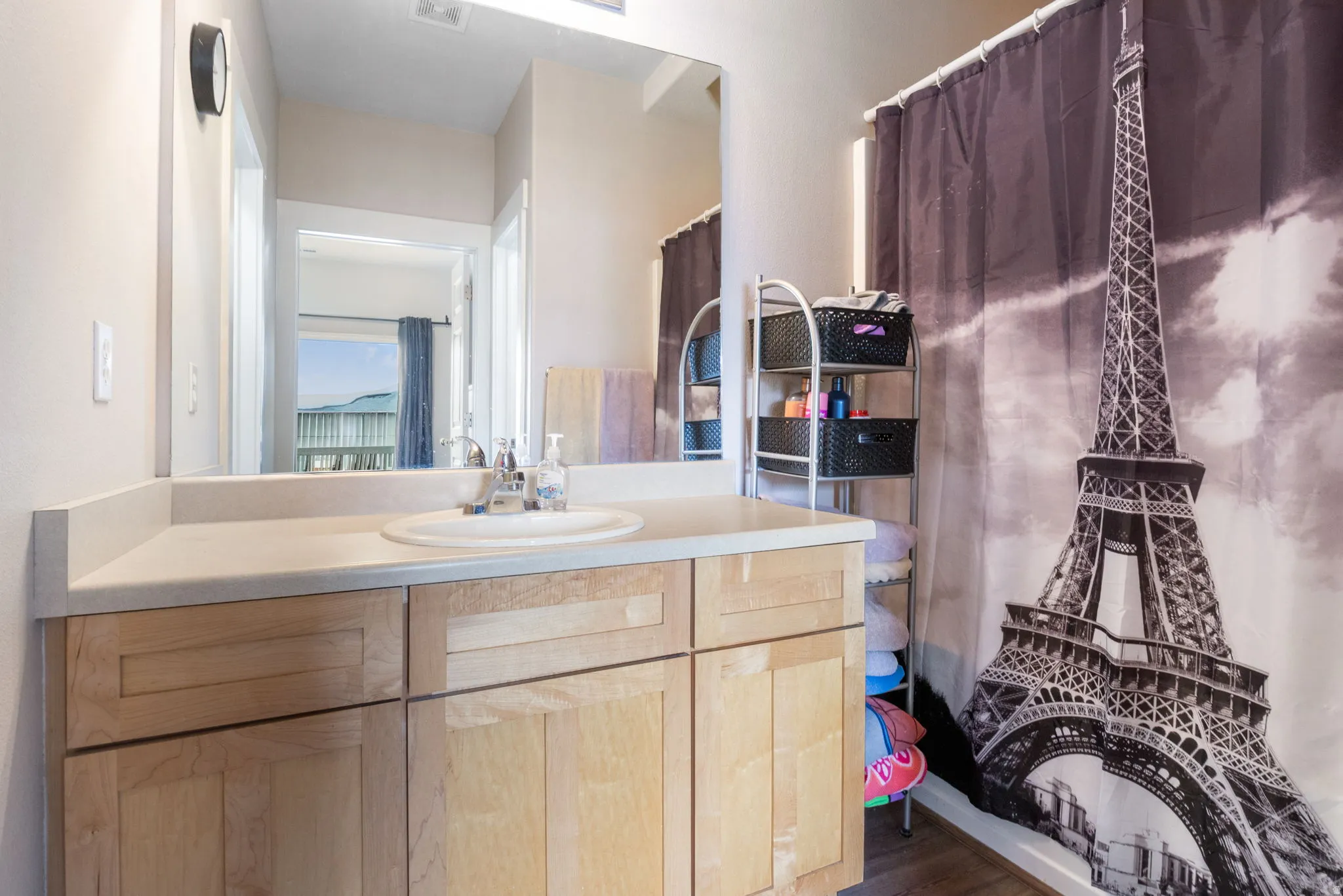 Full bathroom with vanity, a shower with curtain, and dark wood-style floors