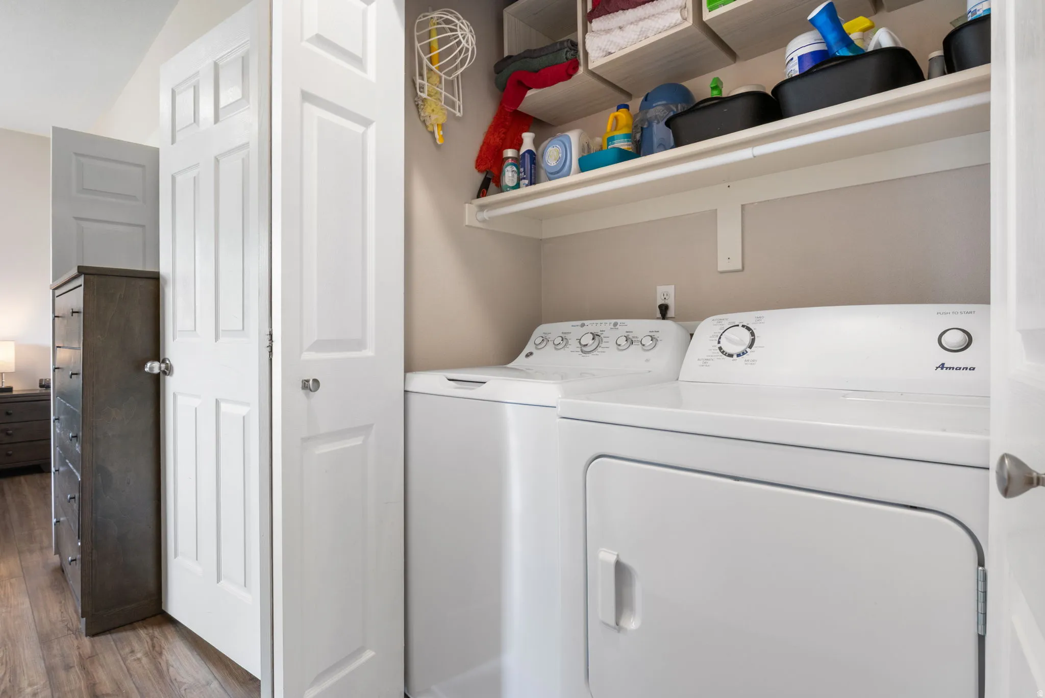 Laundry area featuring separate washer and dryer, dark wood-type flooring, and vaulted ceiling