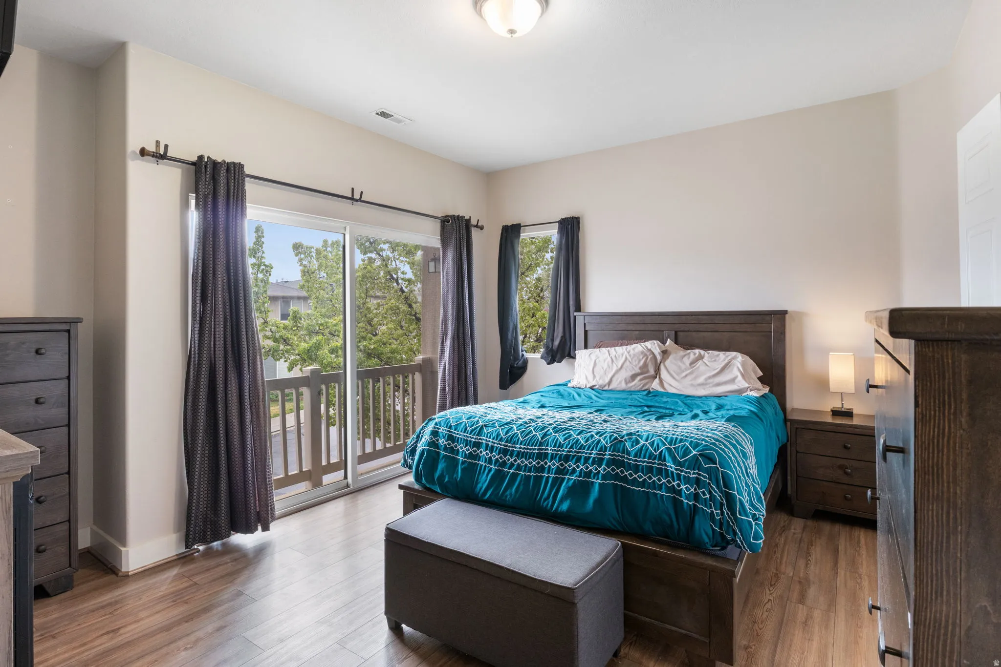 Bedroom featuring access to exterior and wood finished floors