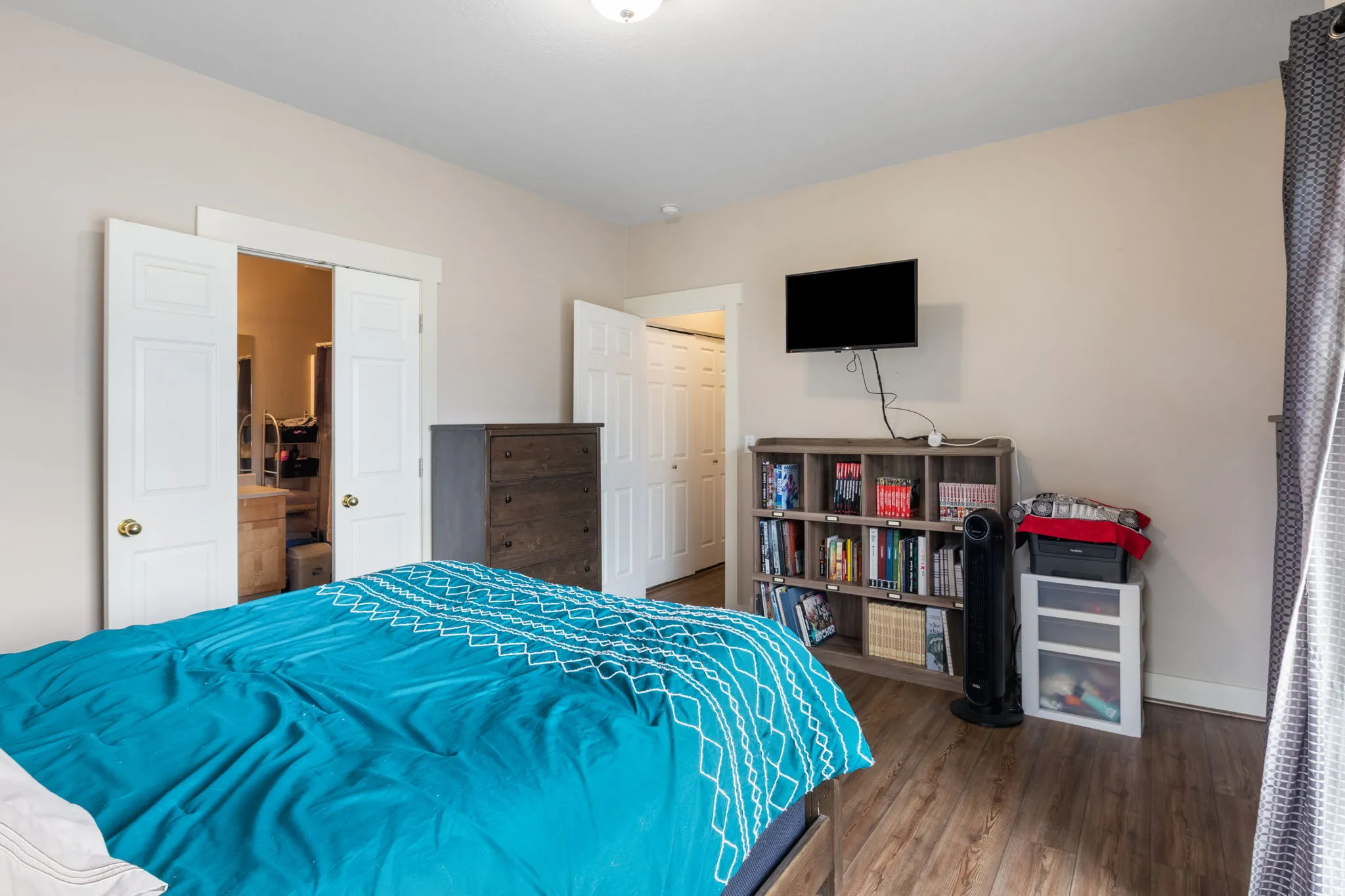 Bedroom featuring dark wood-style flooring and a closet
