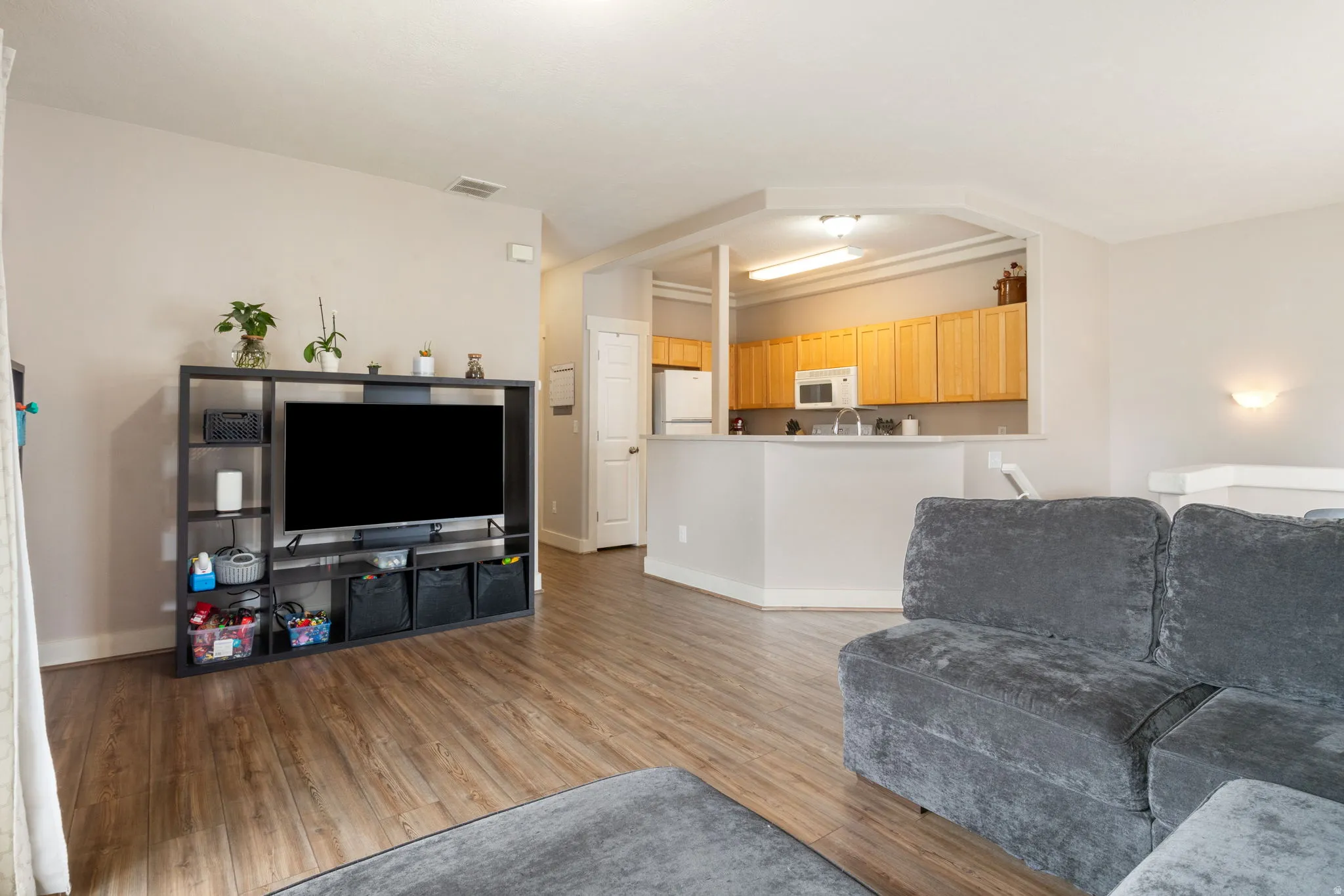 Living room featuring light wood-type flooring and baseboards