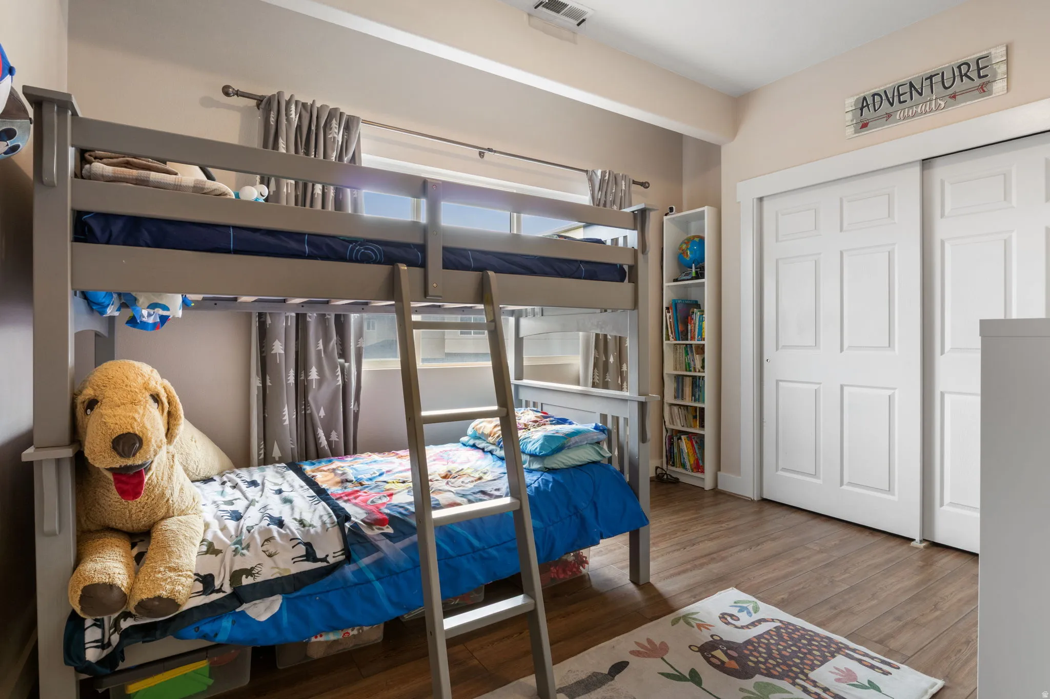 Bedroom featuring dark wood-type flooring and a closet