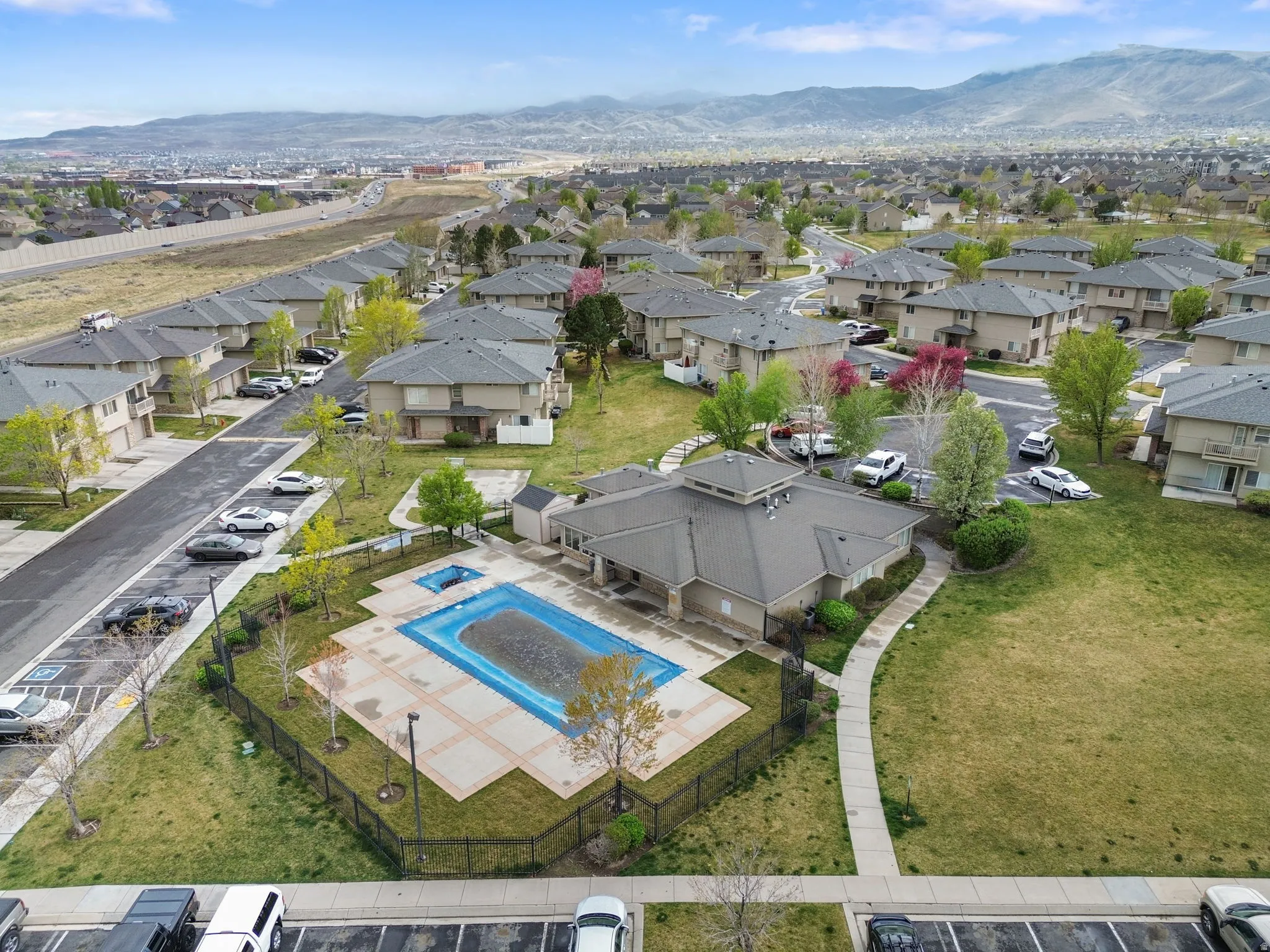 Aerial perspective of suburban area featuring mountains and a pool area