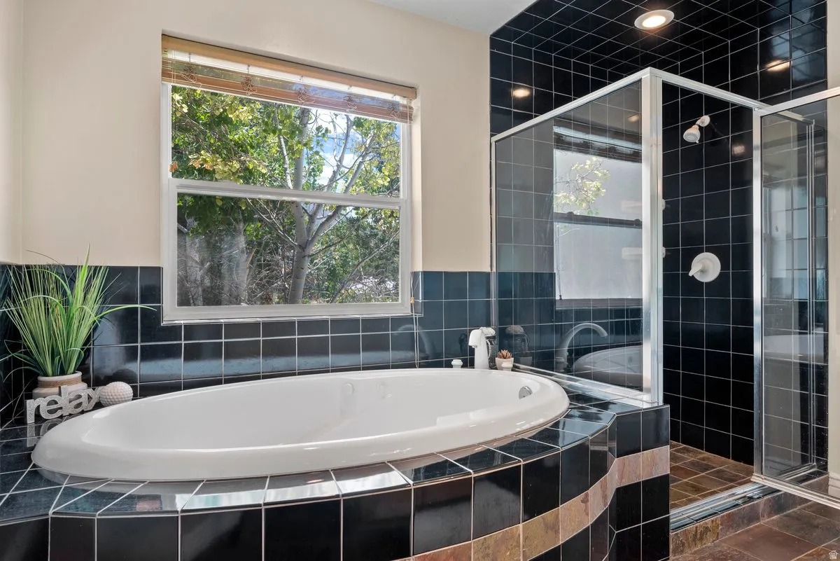 Full bath with a  separate shower and a garden tub