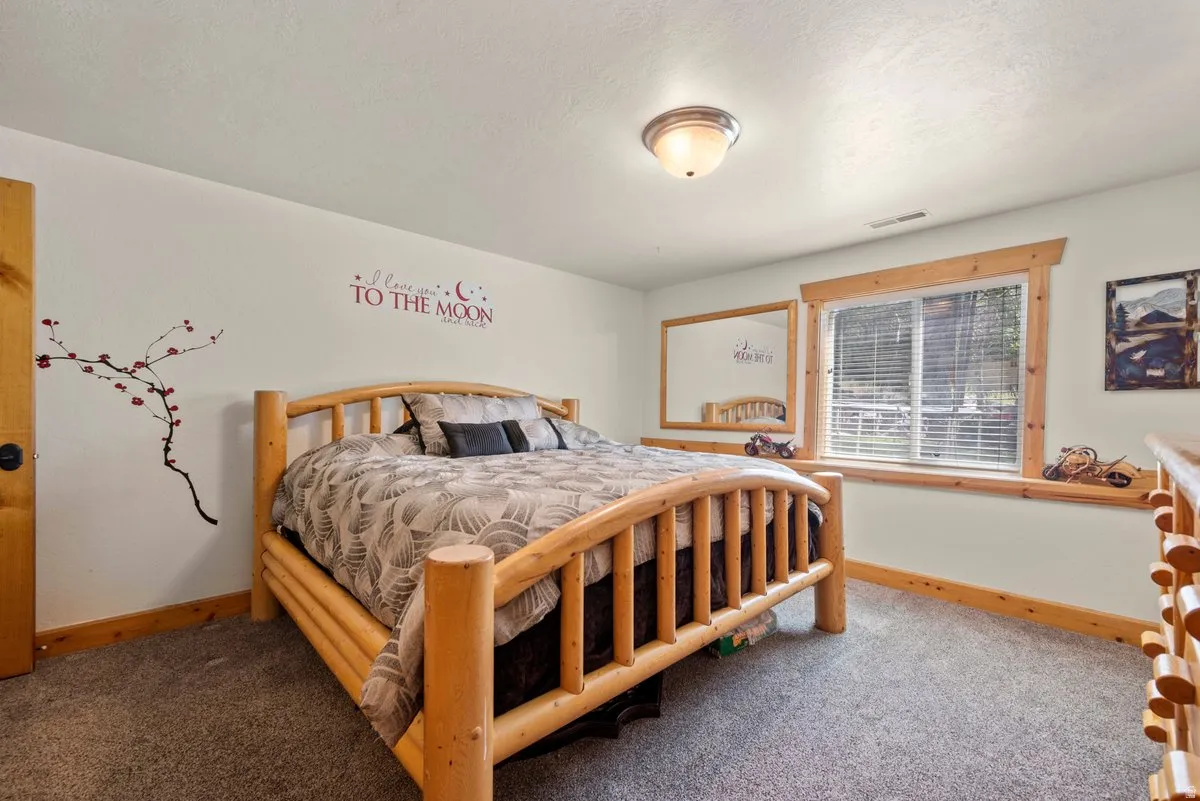 Bedroom featuring custom woodwork and nice window with shelf in wall