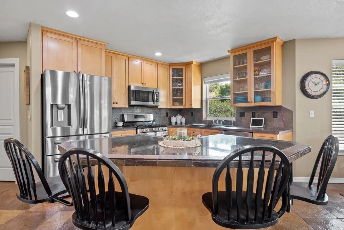 beautiful kitchen cabinetry  stainless steel appliances, a breakfast bar, and a kitchen island