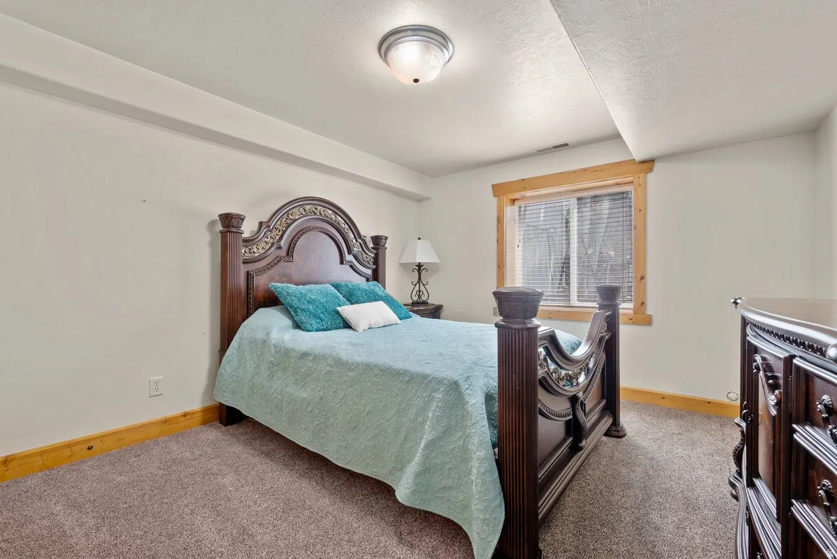 Large bedroom with big window offering natural light