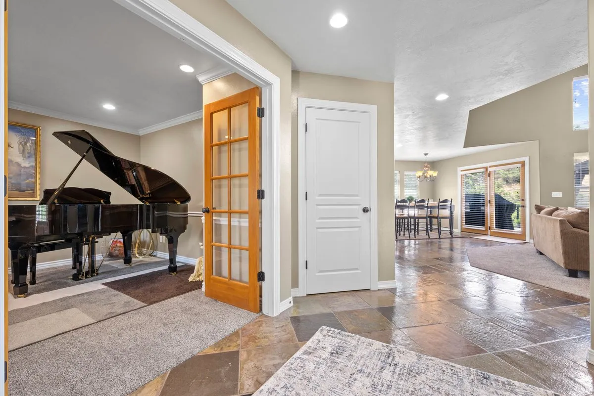 Entryway has an office with french doors, coat closet and calming open feel