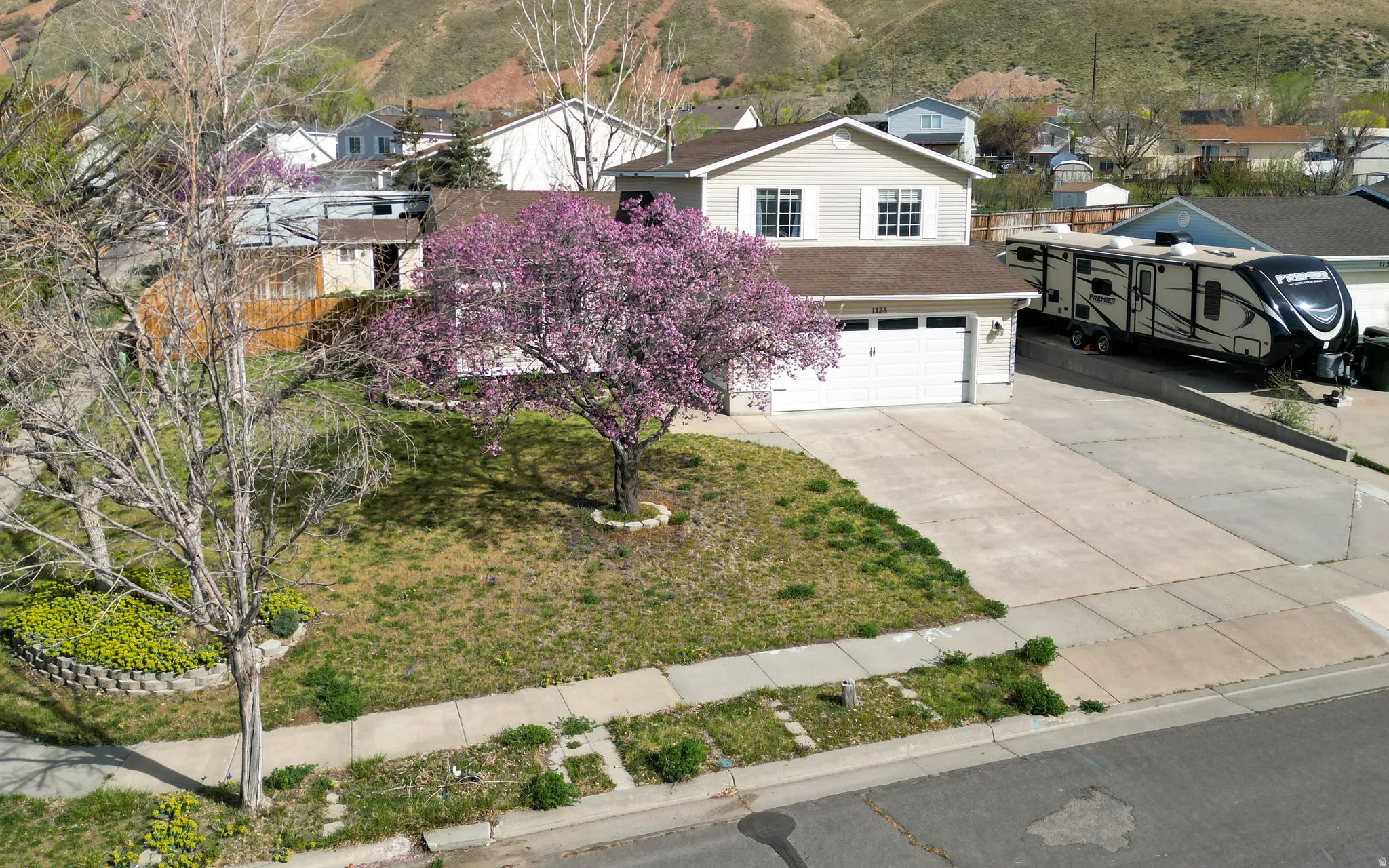 View of front facade with driveway and a garage