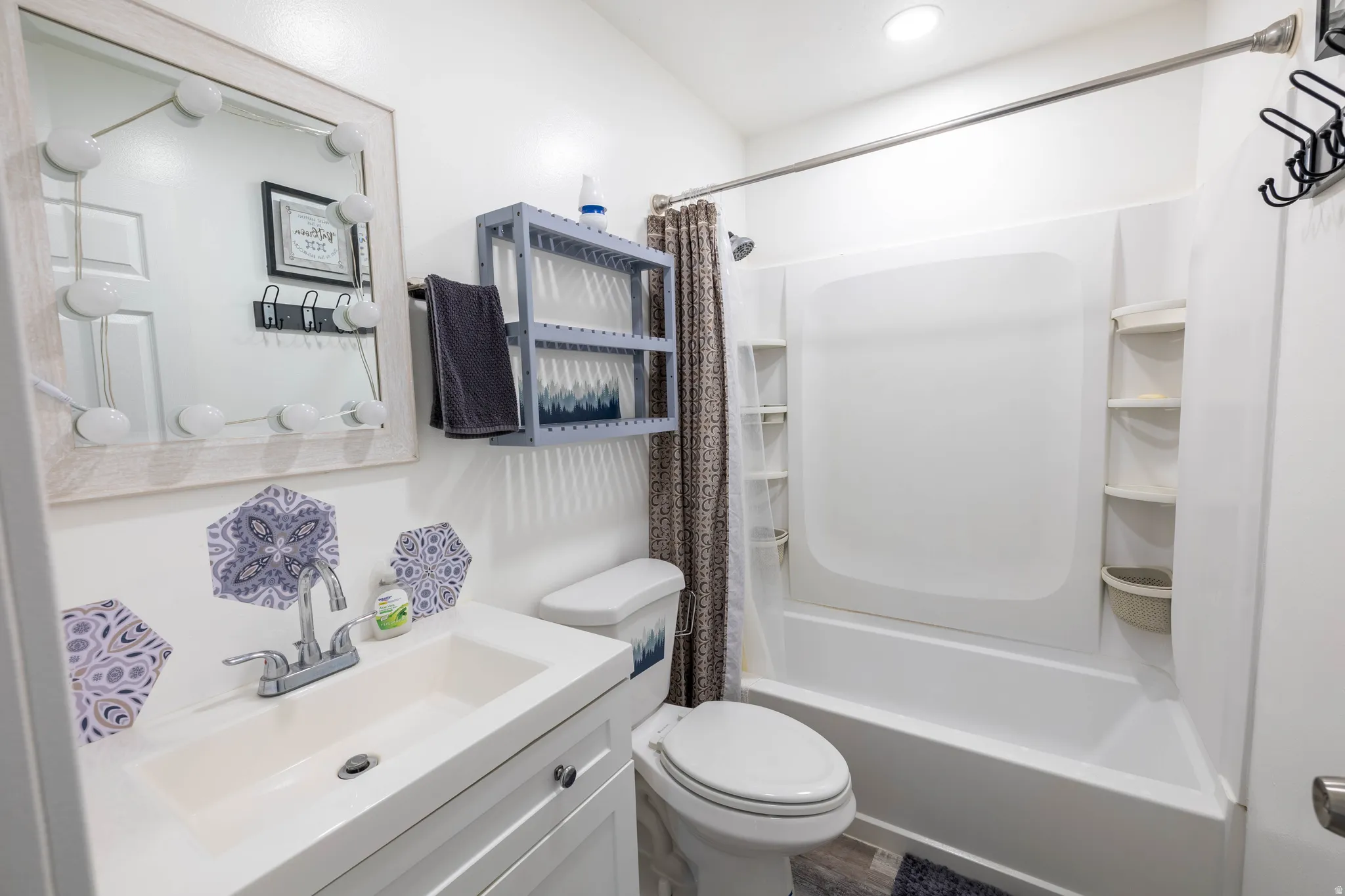Bathroom featuring vanity and shower / bath combo with shower curtain