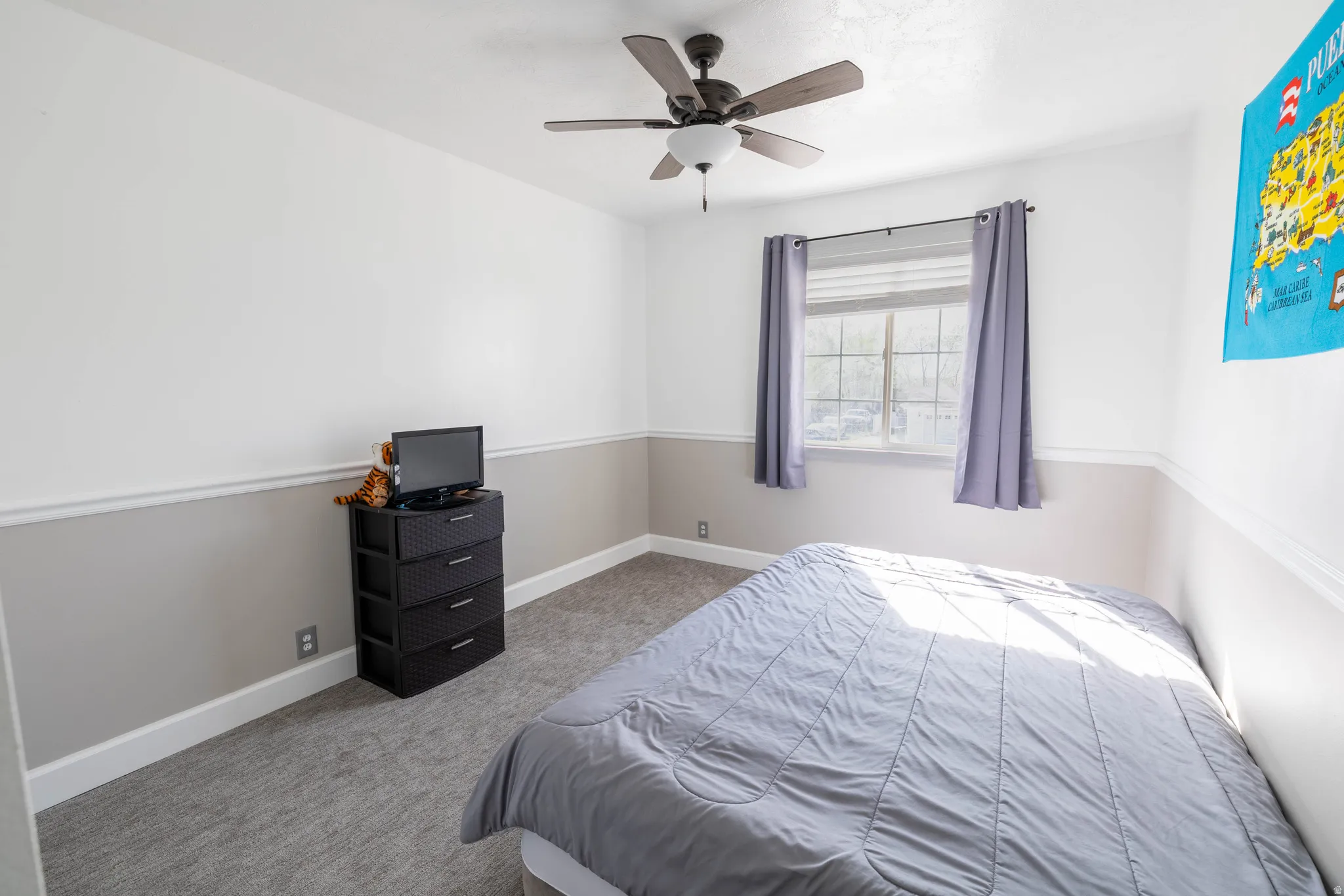 Bedroom featuring light carpet and ceiling fan