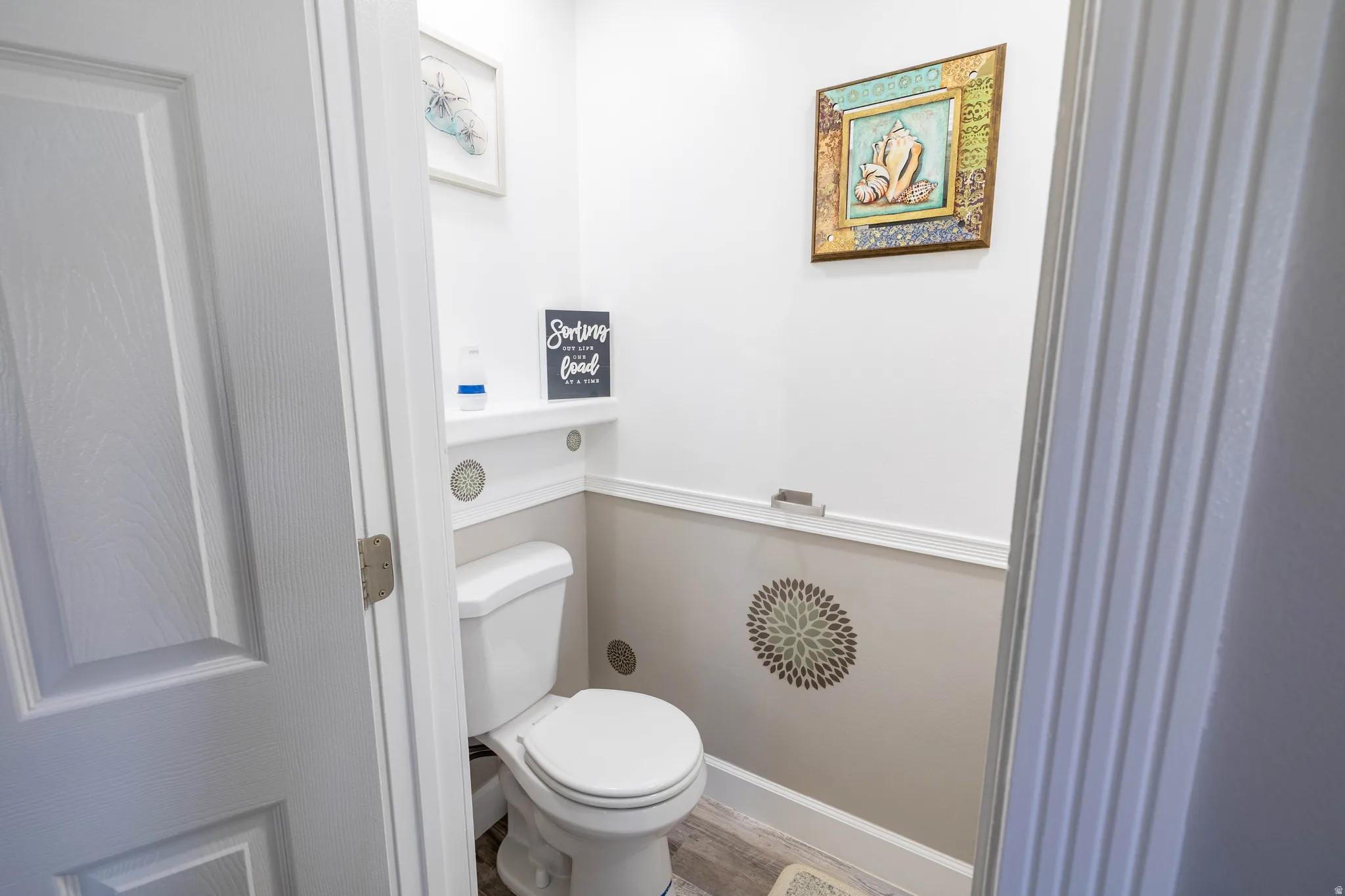 Bathroom featuring toilet and light wood-style flooring