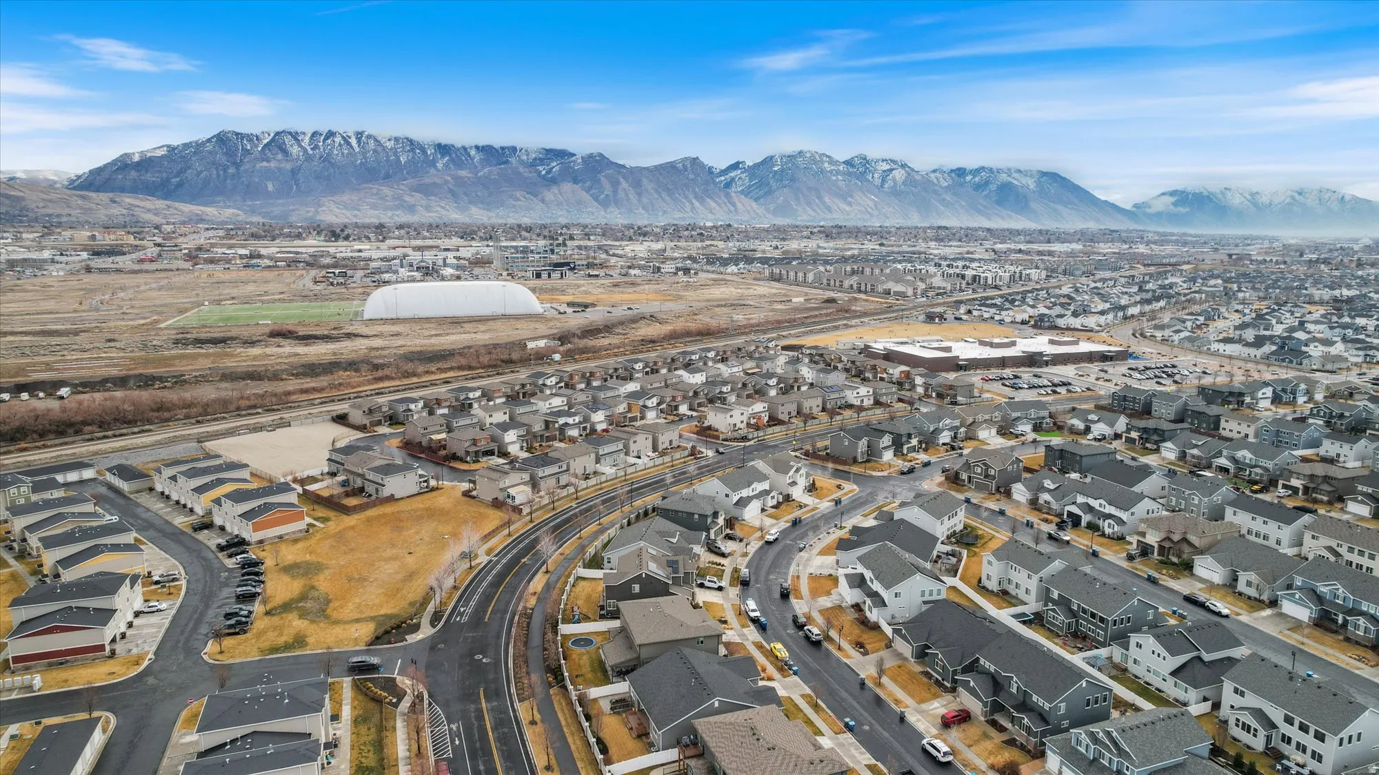 Aerial view of residential area featuring a mountainous background