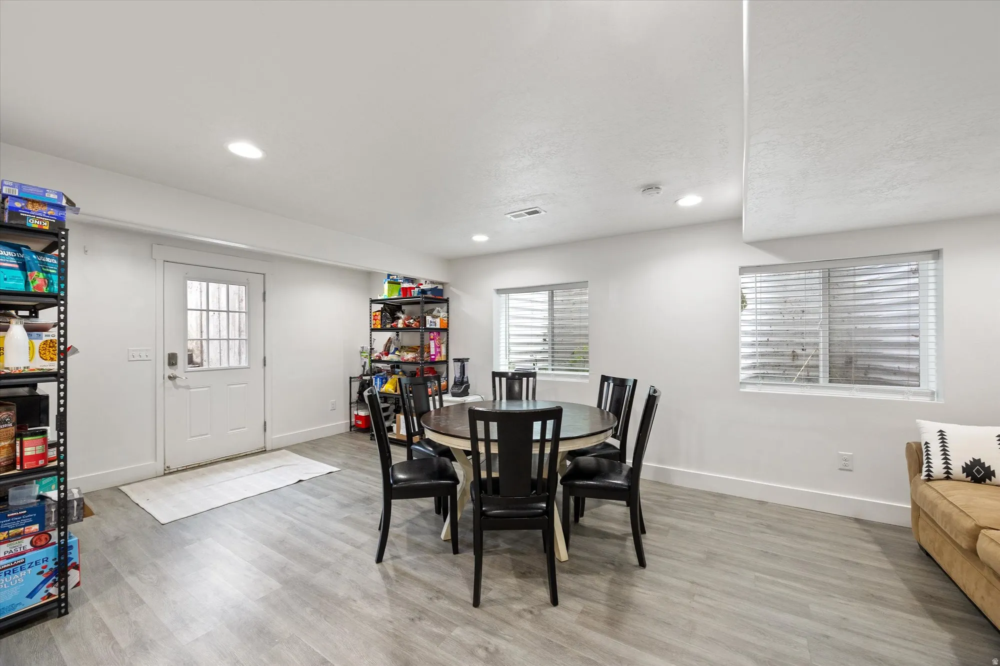 Dining room featuring light wood-style flooring, plenty of natural light, and recessed lighting