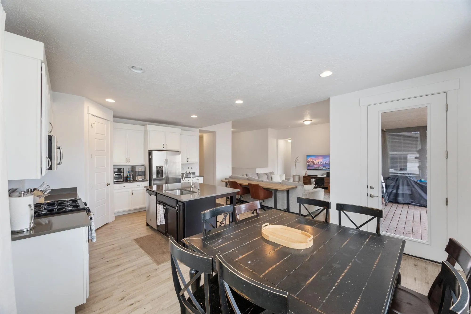 Dining space with light wood-style floors and recessed lighting
