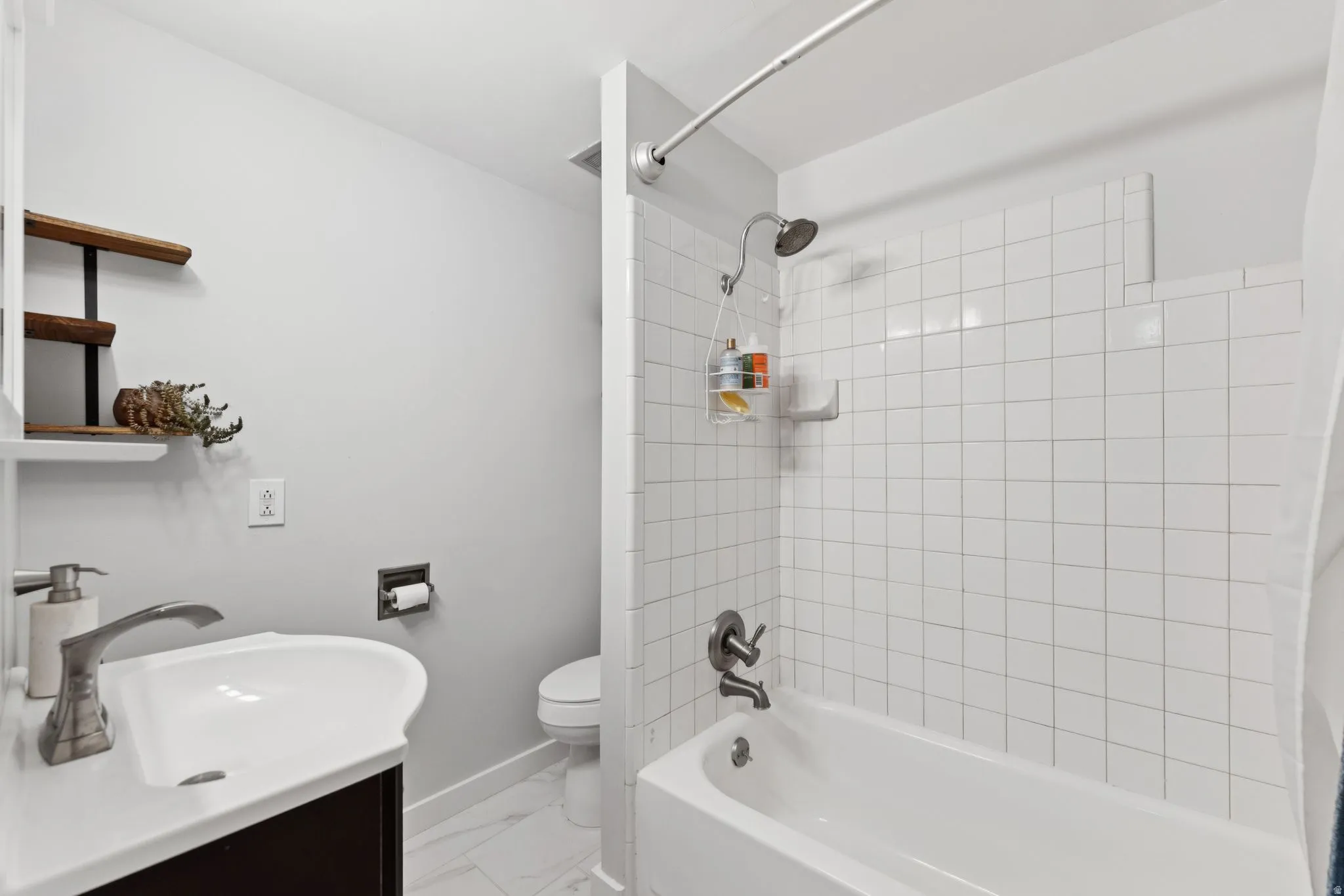 Bathroom featuring vanity and tub / shower combination