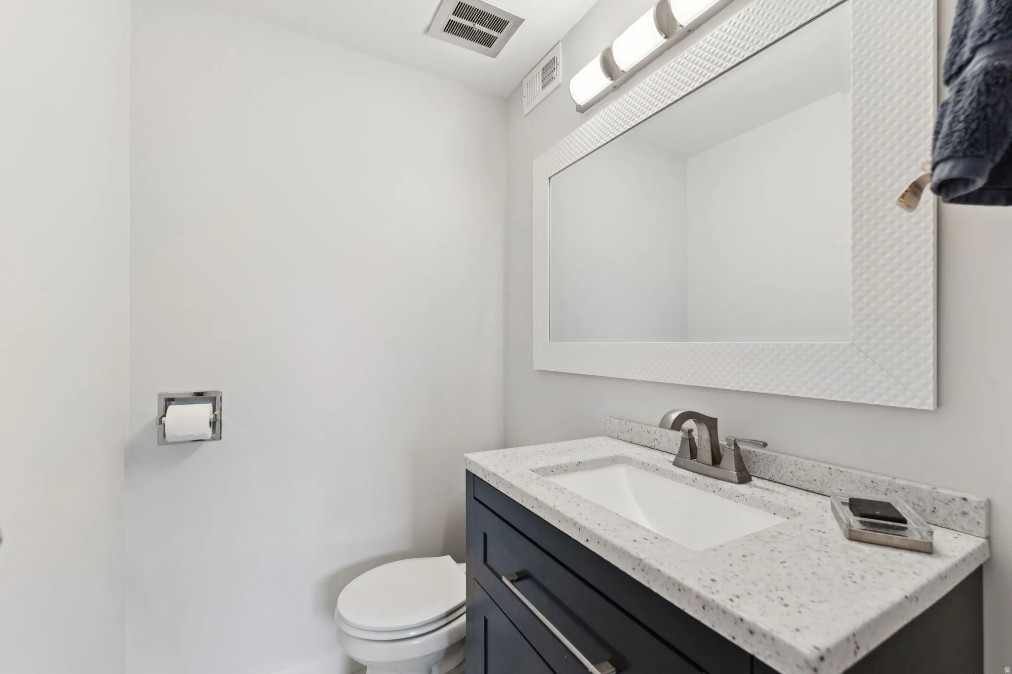 Half bath with vanity and toilet