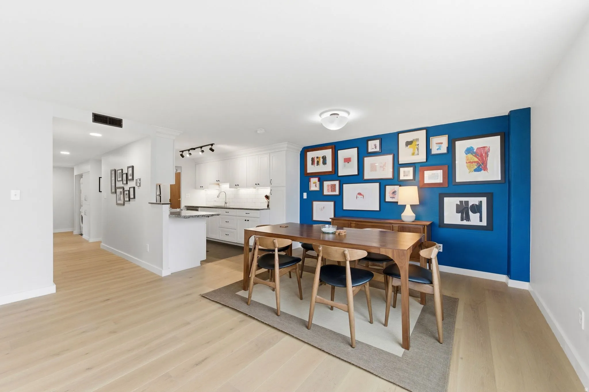 Dining area with light engineered wood flooring and baseboards